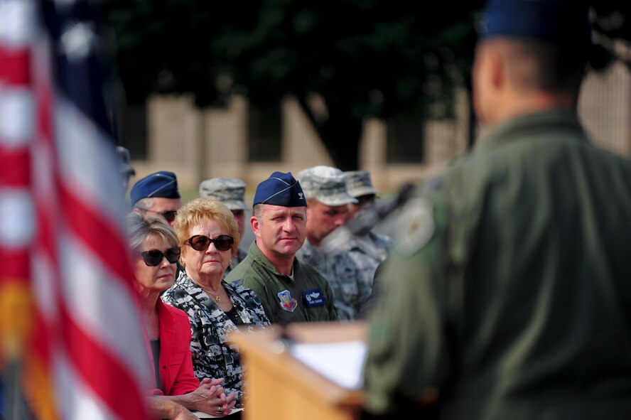 Betty Blesse, wife of retired Maj. Gen. Frederick “Boots” Blesse, and Col. Mark Slocum listen to a guest speaker during a memorial dedication ceremony to honor Betty’s late husband, June 27, 2014, on Seymour Johnson Air Force Base, N.C. During the Korean War, Blesse flew with the 334th Fighter-Interceptor Squadron and was credited with 10 aerial kills, making him one of 11 double aces during the conflict. Slocum is the 4th Fighter Wing commander. (U.S. Air Force photo/Airman 1st Class Brittain Crolley)