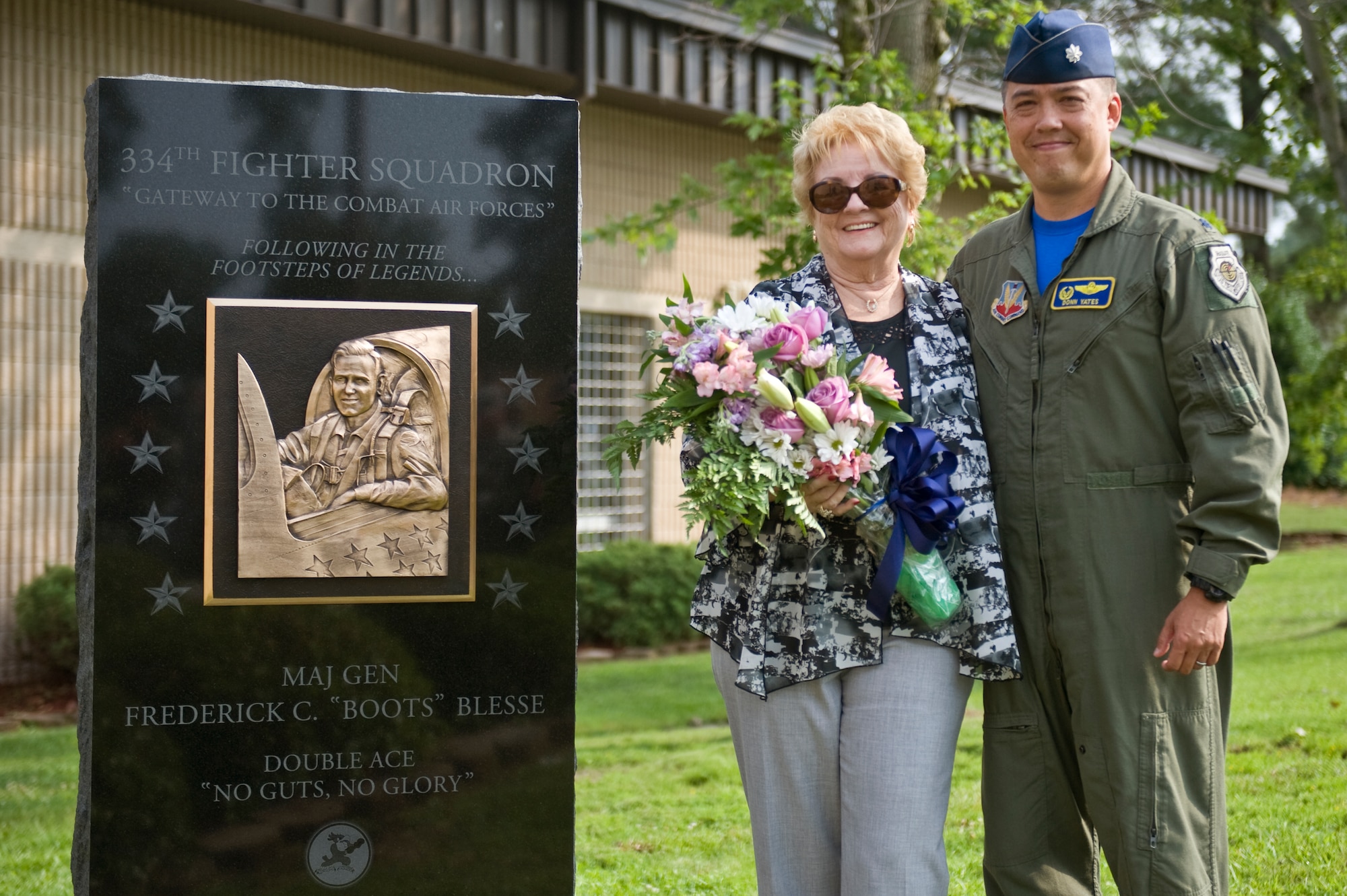 Betty Blesse, wife of retired Maj. Gen. Frederick “Boots” Blesse, stands with Lt. Col. Donn Yates after the unveiling of her late husband’s monument during a memorial dedication ceremony, June 27, 2014, on Seymour Johnson Air Force Base, N.C. The memorial was constructed at the front of the 334th FS, the unit Blesse was assigned to when he recorded his 10th aerial kill. Yates is the 334th Fighter Squadron commander. (U.S. Air Force photo/Airman 1st Class Aaron J. Jenne)