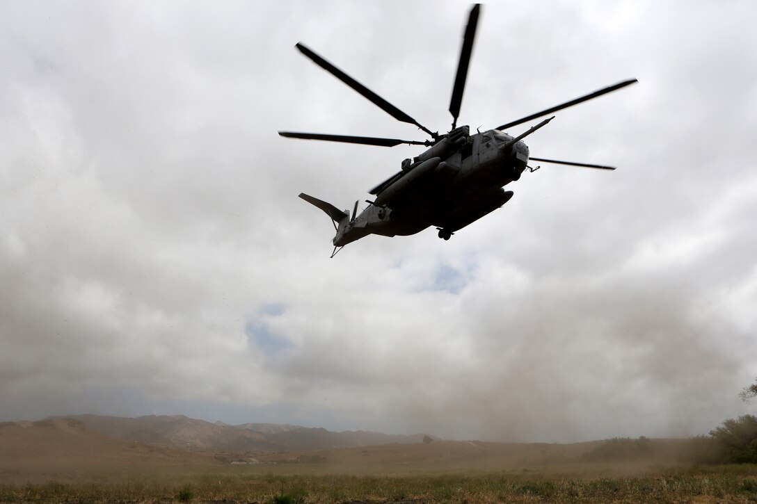 A CH-53E Super Stallion with Marine Heavy Helicopter Squadron (HMH) 465 takes off while carrying Marines to an objective area during training aboard Marine Corps Base Camp Pendleton, Calif., June 27. The training was held to exercise communication techniques between the pilots and ground units.