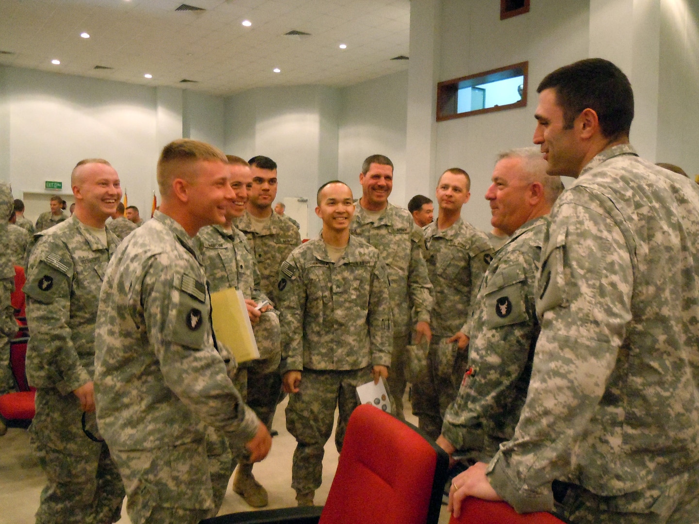 Army 1st Lt. Christopher Bingham (right), commander of Company C, 1st Combined Arms Battalion, 194th Armor; Army 1st Sgt. Tim Flahave (2nd from right), Company C first sergeant, and other Soldiers from Charlie Company 1-194 CAB greet and congratulate Army Spc. Yaroslav Sergei Dmytrochenko (2nd from left) after becoming a naturalized U.S. citizen. Company C, a Minnesota Army National Guard unit, is deployed to Kuwait with the 1st Brigade Combat Team, 34th Infantry Division, in support of Operation New Dawn.
