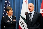Army Col. Sylvia Crockett listens as Gov. Edmund Brown Jr. gives comments prior to her promotion to the rank of brigadier general on March 28, 2012 at the state Capitol in Sacramento, Calif. Crockett is the first Hispanic woman to achieve the rank of general officer in the history of the California National Guard.