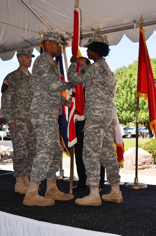 ALBUQUERQUE, N.M., -- Outgoing District Commander Lt. Col. Antoinette Gant (right) hands the Corps of Engineers flag to Brig. Gen. C. David Turner June 26, 2014, signifying the transfer of command responsibility to incoming commander Lt. Col. Patrick Dagon (left).