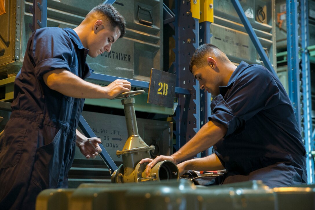 Lance Cpls. Isaih Alamillo, left, and Jonathan A. Ramos double-check a water valve during a mobility exercise June 18 on Camp Hansen. This was part of an exercise to test the Marines on their response time in case they are needed for a deployment. Alamillo is a Los Angeles, California, native, and Ramos is a Staten Island, New York, native. Both are bulk fuel specialists with Bulk Fuel Company, 9th Engineer Support Battalion, 3rd Marine Logistics Group, III Marine Expeditionary Force. (U.S. Marine Corps photo by Lance Cpl. Robert Williams Jr./Released)


