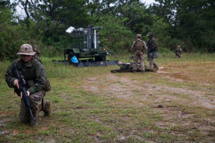 Lance Cpl. Christopher J. Rieger, left, provides security as his fellow Marines call in a simulated casualty evacuation June 24 during Exercise Coral Thunder at Kadena Air Base. Remaining alert while providing security ensured the mock casualty was safely evacuated from the potentially dangerous situation. Rieger is a Butler, Pennsylvania, native and refrigeration and air conditioning technician with Marine Air Support Squadron 2, Marine Air Control Group 18, 1st Marine Aircraft Wing, III Marine Expeditionary Force.