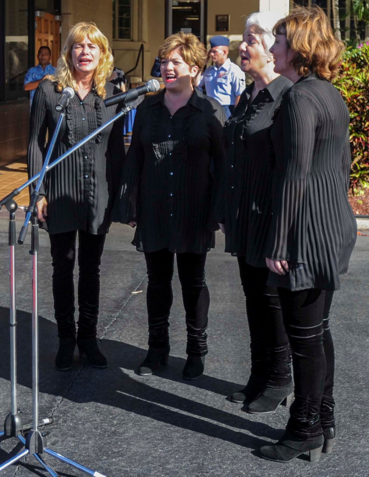 Members of the Aloha Spirit quartet sing the National Anthem during the 15th Wing change of command ceremony on the Joint Base Pearl Harbor-Hickam flightline June 27, 2014. During the ceremony, Col. Randall Huiss took command of the wing from Col. Johnny Roscoe.  (U.S. Air Force photo/Tech. Sgt. Terri Paden)