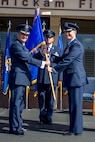 Lt. Gen. Russell Handy, Eleventh Air Force commander, passes the 15th Wing guidon to Col. Randall Huiss, the incoming 15th Wing commander, during the change of command ceremony June 27, 2014, on the Joint Base Pearl Harbor-Hickam flightline. During the ceremony, Huiss took command of the wing from Col. Johnny Roscoe. (U.S. Air Force photo/Tech. Sgt. Terri Paden)