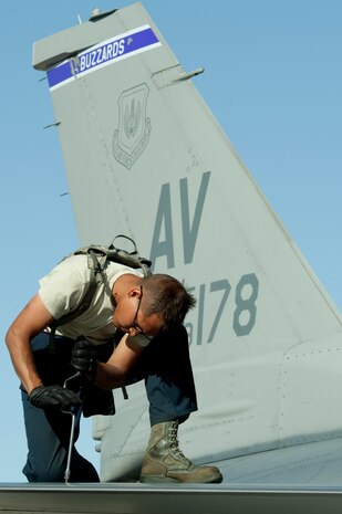 U.S Air Force Airman 1st Class Gabriel Toledo-Navarro, a crew chief assigned to the 510th Aircraft Maintenance Unit, Aviano Air Base, Italy, performs post flight maintenance on an F-16 Fighting Falcon from the 31st Fighter Wing, Aviano AB, during Green Flag West 14-8, June 26, 2014, at Nellis Air Force Base, Nev. In addition to being a valuable training opportunity for flight crews, Green Flag West provides ground crews the chance to hone their skills in a realistic environment. (U.S. Air Force photo by Senior Airman Timothy Young)