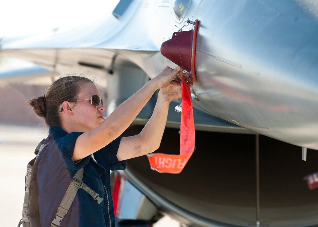 U.S. Air Force Airman Kacy Cotham, a crew chief assigned to the 510th Aircraft Maintenance Unit, Aviano Air Base, Italy, goes through post-flight procedures on an F-16 Fighting Falcon from the 31st Fighter Wing, Aviano AB, during Green Flag West 14-8, June 26, 2014, at Nellis Air Force Base, Nev. Green Flag West provides critical training to air and ground crews with scenarios to prepare them for future real-world missions. (U.S. Air Force photo by Airman 1st Class Thomas Spangler)