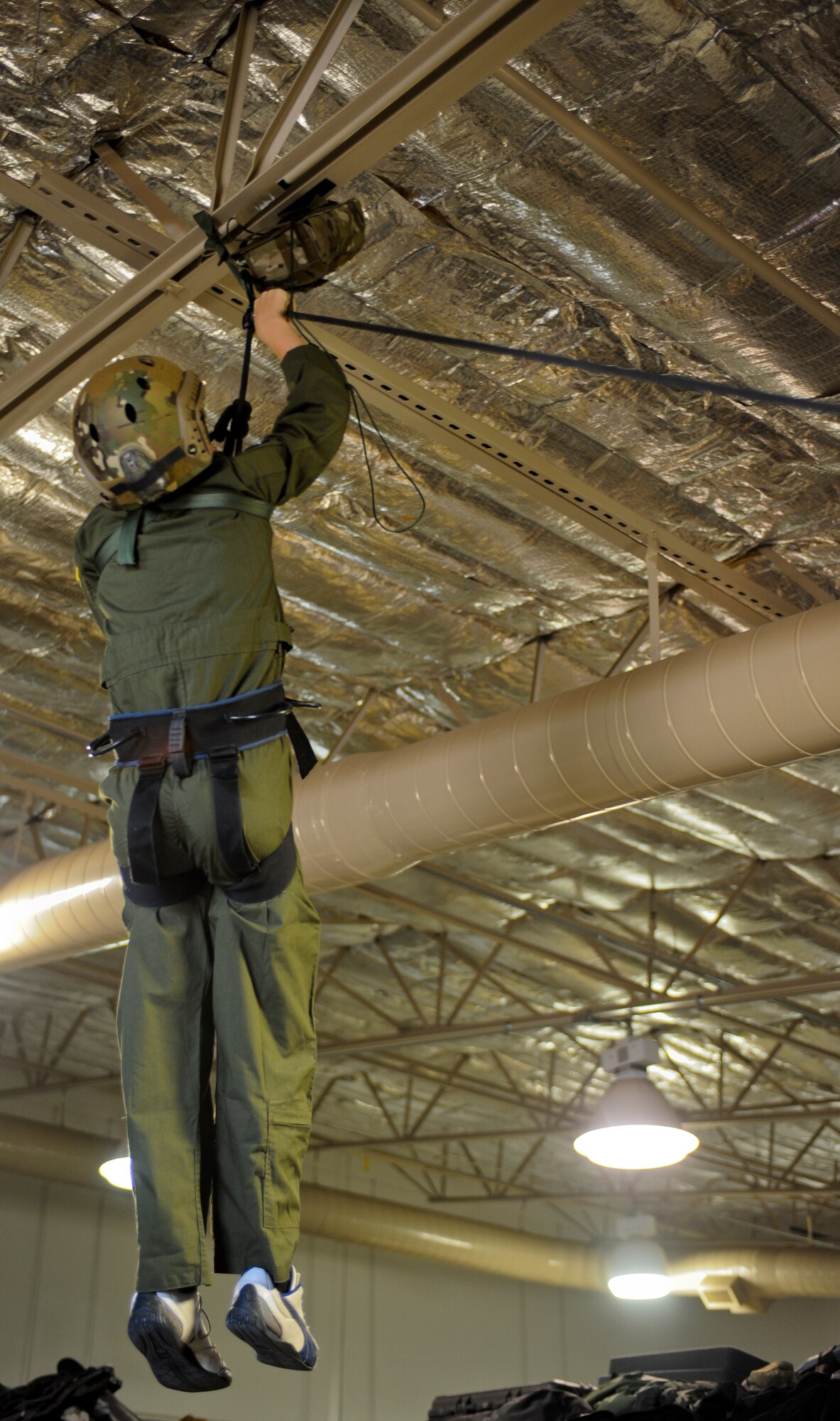 Trevor Pahl, 10, retrieves a package while completing a rescue scenario during a Pilot for a Day event at Davis-Monthan Air Force Base, Ariz., June 27, 2014. The goal of the Pilot for a Day program is to provide children, who have serious or chronic conditions, and their families with the opportunity to be a guest of the 355th Fighter Wing and one of D-M's squadrons for a day. (U.S. Air Force photo by Airman 1st Class Sivan Veazie/Released)
