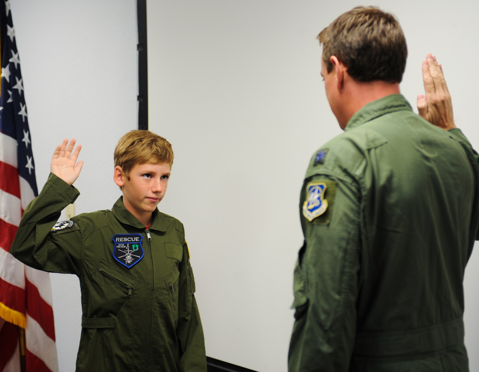 Trevor Pahl, 10, recites an oath of enlistment during a Pilot for a Day event at Davis-Monthan Air Force Base, Ariz., June 27, 2014. Pahl suffered from a traumatic brain injury a year ago and was selected to be a honorary pilot for a day. (U.S. Air Force photo by Airman 1st Class Sivan Veazie/Released)