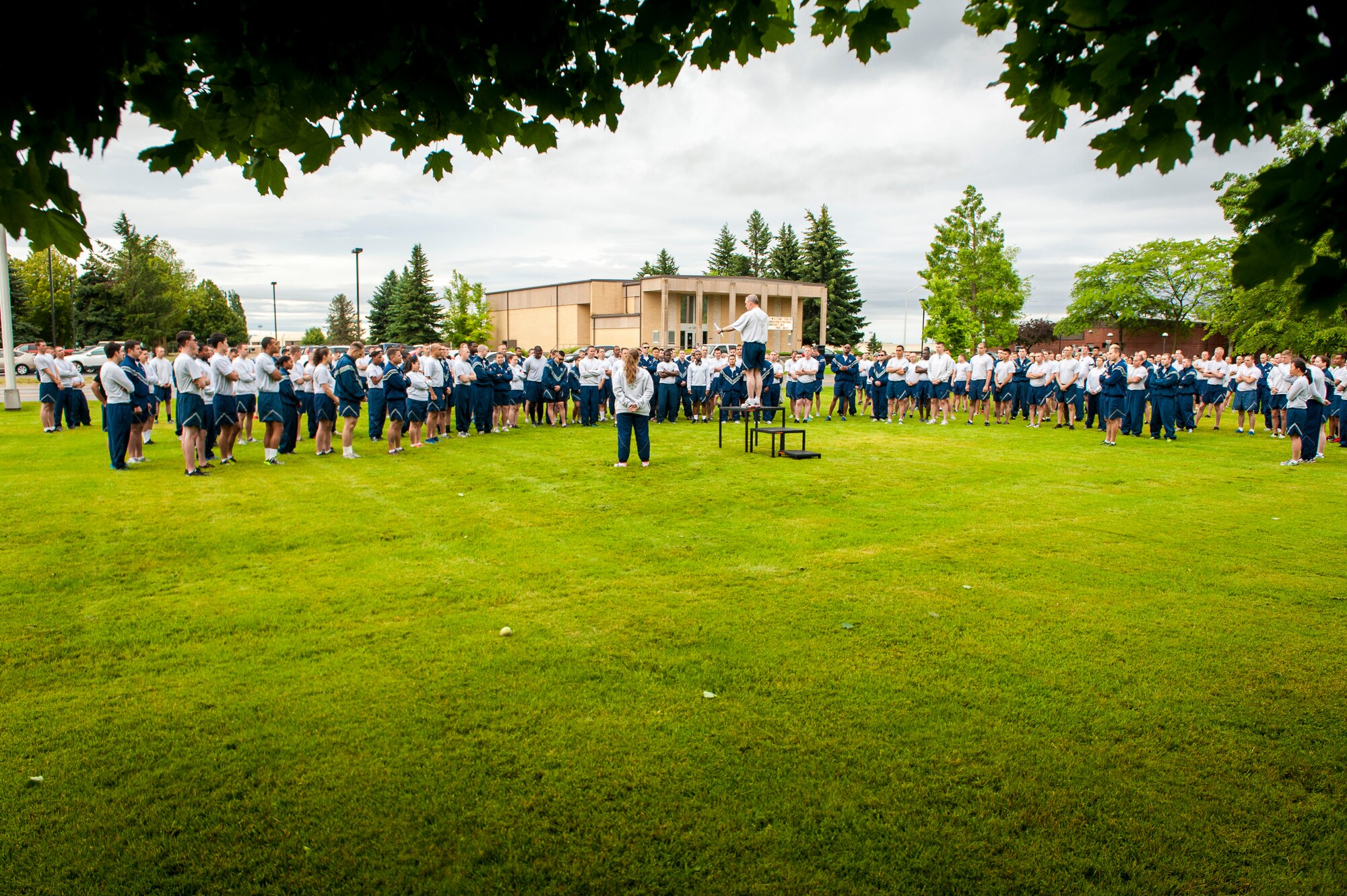 Col. Brian Newberry thanks Airmen for attending the monthly wing run at Fairchild Air Force Base, Washington, June 27, 2014. Wing runs allow Airmen to personally assess their physical fitness and enhance unit cohesion through team morale and welfare. Newberry is the 92nd Air Refueling Wing commander. (U.S. Air Force photo by Staff Sgt. Benjamin W. Stratton/Released)