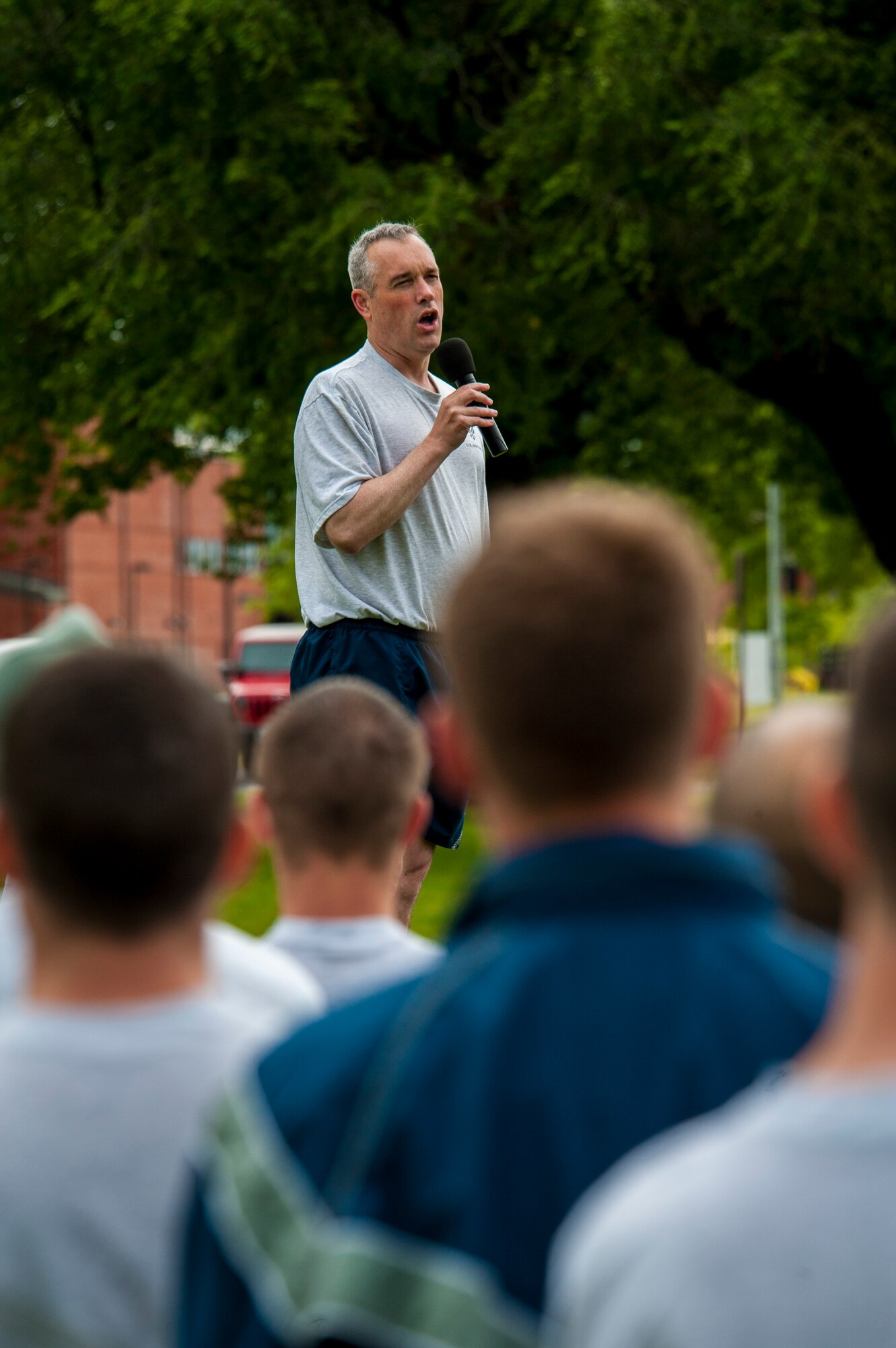 Col. Brian Newberry thanks Airmen for attending the monthly wing run at Fairchild Air Force Base, Washington, June 27, 2014. Wing runs allow Airmen to personally assess their physical fitness and enhance unit cohesion through team morale and welfare. Newberry is the 92nd Air Refueling Wing commander. (U.S. Air Force photo by Staff Sgt. Benjamin W. Stratton/Released)