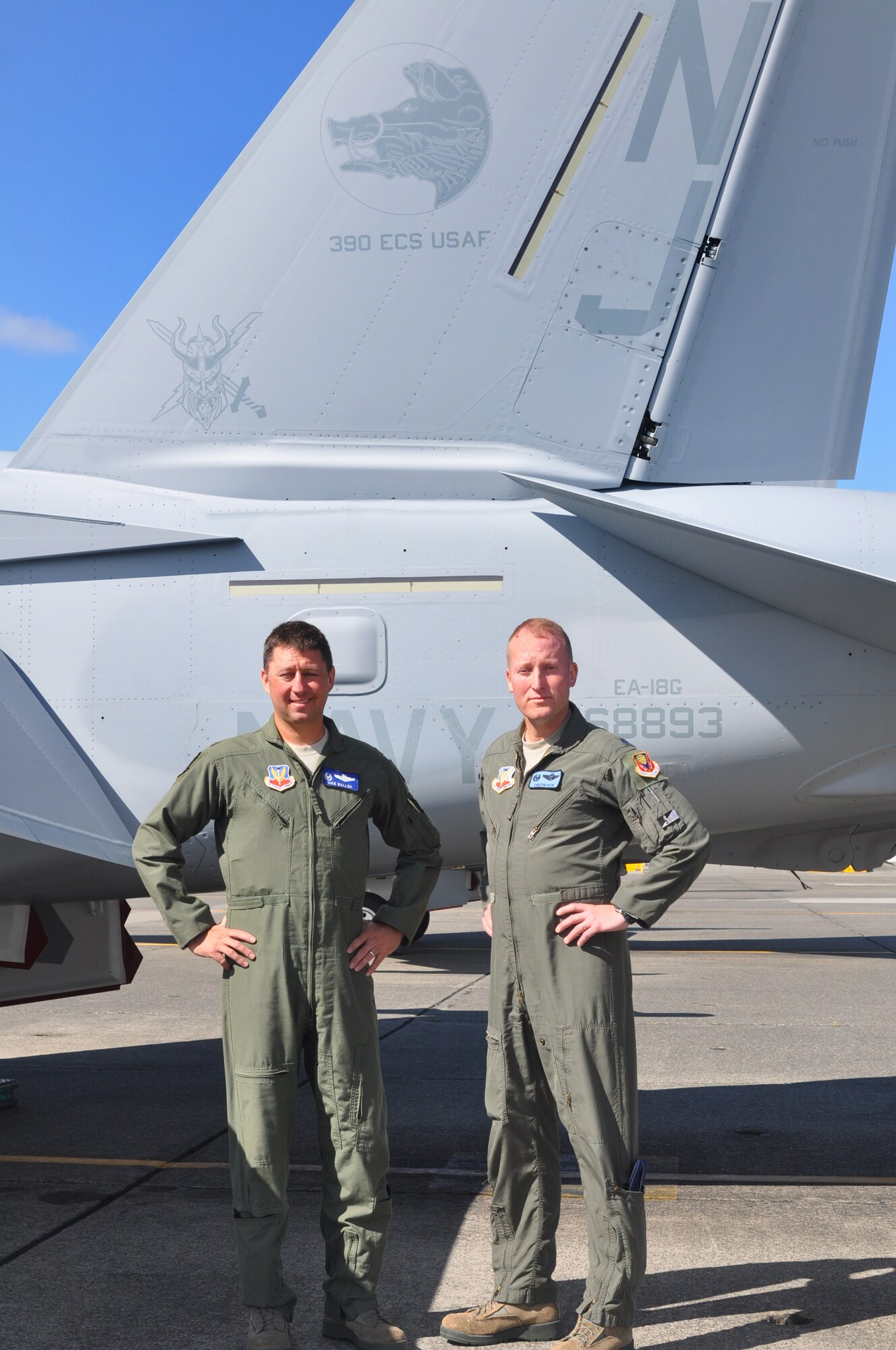 Col. Michael Ballek, 366th Operations Group commander, and Lt. Col. Carlton Keen, 390th Electronic Combat Squadron commander, stand for a photo at Naval Air Station Whidbey Island, Wash., in front a VAQ-129 EA-18G Growler painted with the 390th ECS Wild Boar logo. Ballek is visiting the 390th ECS and the Navy Electronic Attack Wing to hold discussions and observe the Air Force and Navy integration process for the electronic attack mission. This was Ballek’s second visit to NAS Whidbey Island since taking command of the 366th Operations Group in August, 2013. “I’m very enthused with the integration process I’ve observed thus far,” Ballek said. “I’m also pleased that the Navy has been great with welcoming our Air Force aviators into the community here. That’s a great testament to the Team Whidbey concept.”
