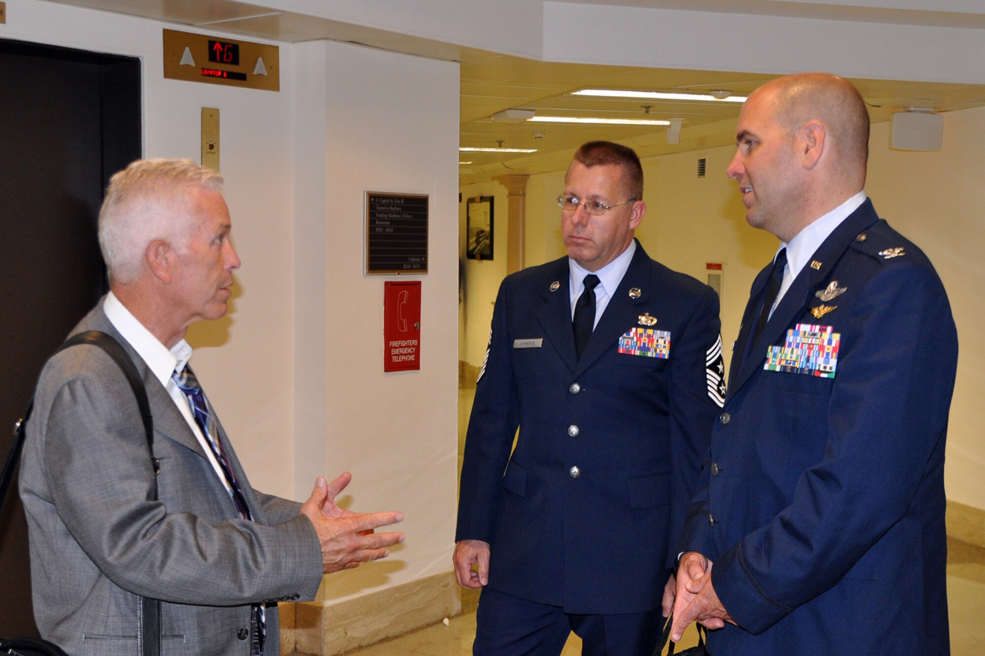 WASHINGTON, D.C. -- Air Force Reserve Col. James Dignan (right), commander of the 910th Airlift Wing, and Chief Master Sgt. Steven Larwood (center), command chief of the 910th Airlift Wing, based at Youngstown Air Reserve Station (YARS), Ohio talk with Congressman Bill Johnson, Ohio 13th district during an impromptu meeting here, June 26, 2014. Dignan and Larwood would later visit the congressman’s office staff to discuss the 910th’s mission as well as several issues concerning the unit and installation as part of the commander’s Air Force Reserve Capitol Hill Visit program, June 25 and 26, 2014. As the 910th’s senior enlisted member, Larwood accompanied the commander to lend his perspective on how issues concerning the unit and installation affect the wing’s personnel especially the enlisted force.  The primary purpose of the program is to assist commanders in improving and building on relationships established with Congressional delegations and to increase their unit’s visibility with members of Congress. U.S. Air Force photo by Master Sgt. Bob Barko Jr.