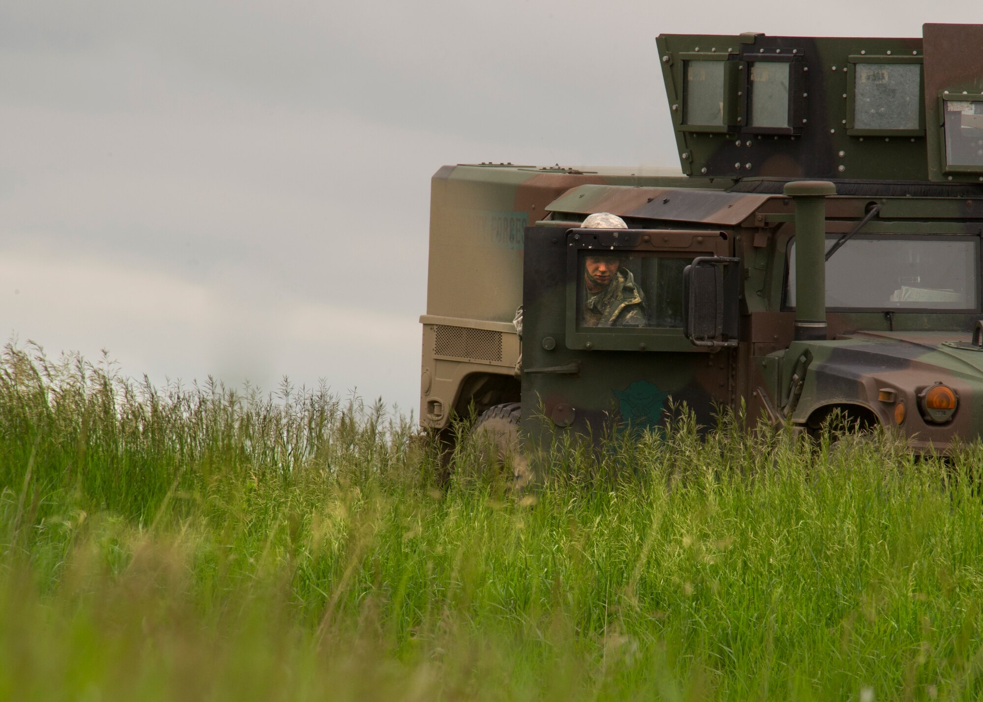 An Airman from the 791st Missile Security Forces Squadron takes cover during a recapture, recovery exercise in North Dakota, June 26, 2014. The exercise is to evaluate the response of infield forces to an attack at a simulated breached site. (U.S. Air Force photo/Senior Airman Brittany Y. Bateman)