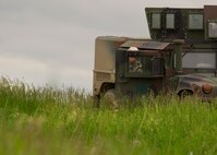 An Airman from the 791st Missile Security Forces Squadron takes cover during a recapture, recovery exercise in North Dakota, June 26, 2014. The exercise is to evaluate the response of infield forces to an attack at a simulated breached site. (U.S. Air Force photo/Senior Airman Brittany Y. Bateman)