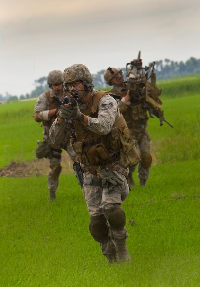 Tactical Response Force members approach a launch facility during a recapture, recovery exercise in North Dakota, June 26, 2014. The exercise is to evaluate the response of infield forces to an attack at a simulated breached site. (U.S. Air Force photo/Senior Airman Brittany Y. Bateman)