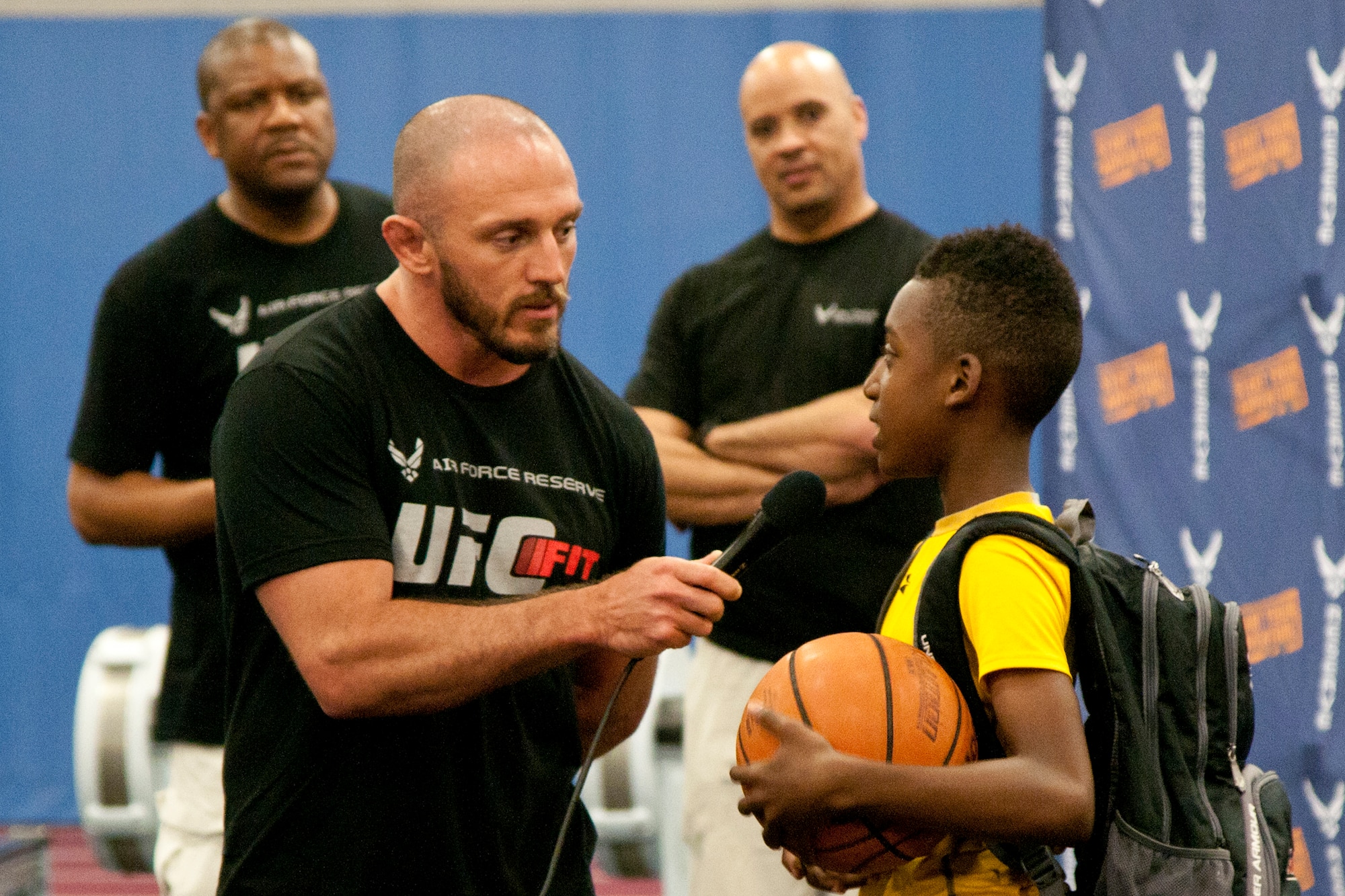 Mike Dolce, an Ultimate Fighting Championship FIT coach, takes a question from a young man at the Tactical Fitness Center on Joint Base Andrews, Md., June 24, 2014.  The UFC FIT program taught attendees about achieving maximum physical fitness through living a healthy lifestyle, and was sponsored by the Air Force Reserve. (U.S. Air Force photo/Airman 1st Class J.D. Maidens)