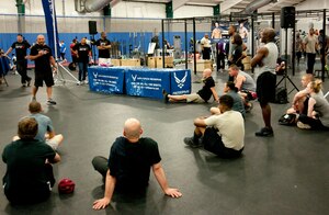 Mike Dolce, an Ultimate Fighting Championship FIT coach, speaks to a crowd at the Tactical Fitness Center on Joint Base Andrews, Md., June 24, 2014. The UFC FIT program taught attendees about achieving maximum physical fitness through living a healthy lifestyle, and was sponsored by the Air Force Reserve. (U.S. Air Force photo/Airman 1st Class J.D. Maidens)