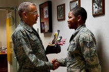 Maj. Gen. Jack Weinstein, 20th Air Force commander, presents Staff Sgt. David Wallace III, 91st Security Forces Group plans and programs, the Air Force 12 Outstanding Airmen of the Year Award at Minot Air Force Base, N.D., June 25, 2014. (U.S. Air Force photo/Senior Airman Brittany Y. Bateman)  