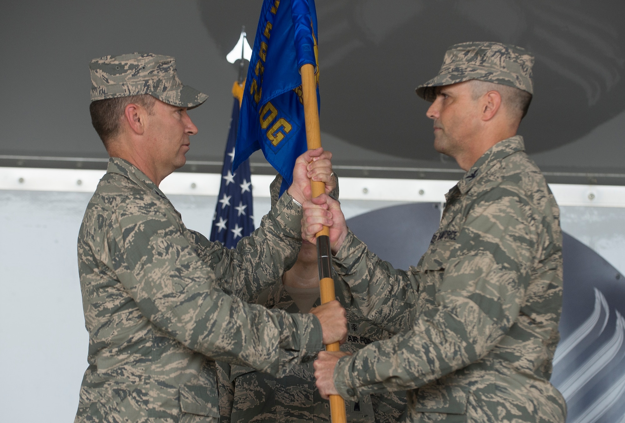 U.S. Air Force Col. Peter Breed, right, receives the guidon from Col. Chad Franks, 23d Wing commander, after assuming command of the 23d Medical Group June 30, 2014, at Moody Air Force Base, Ga. The passing of the guidon is symbolic of a new commander taking command of a military unit. (U.S. Air Force Photo by Airman Dillian Bamman/Released) 