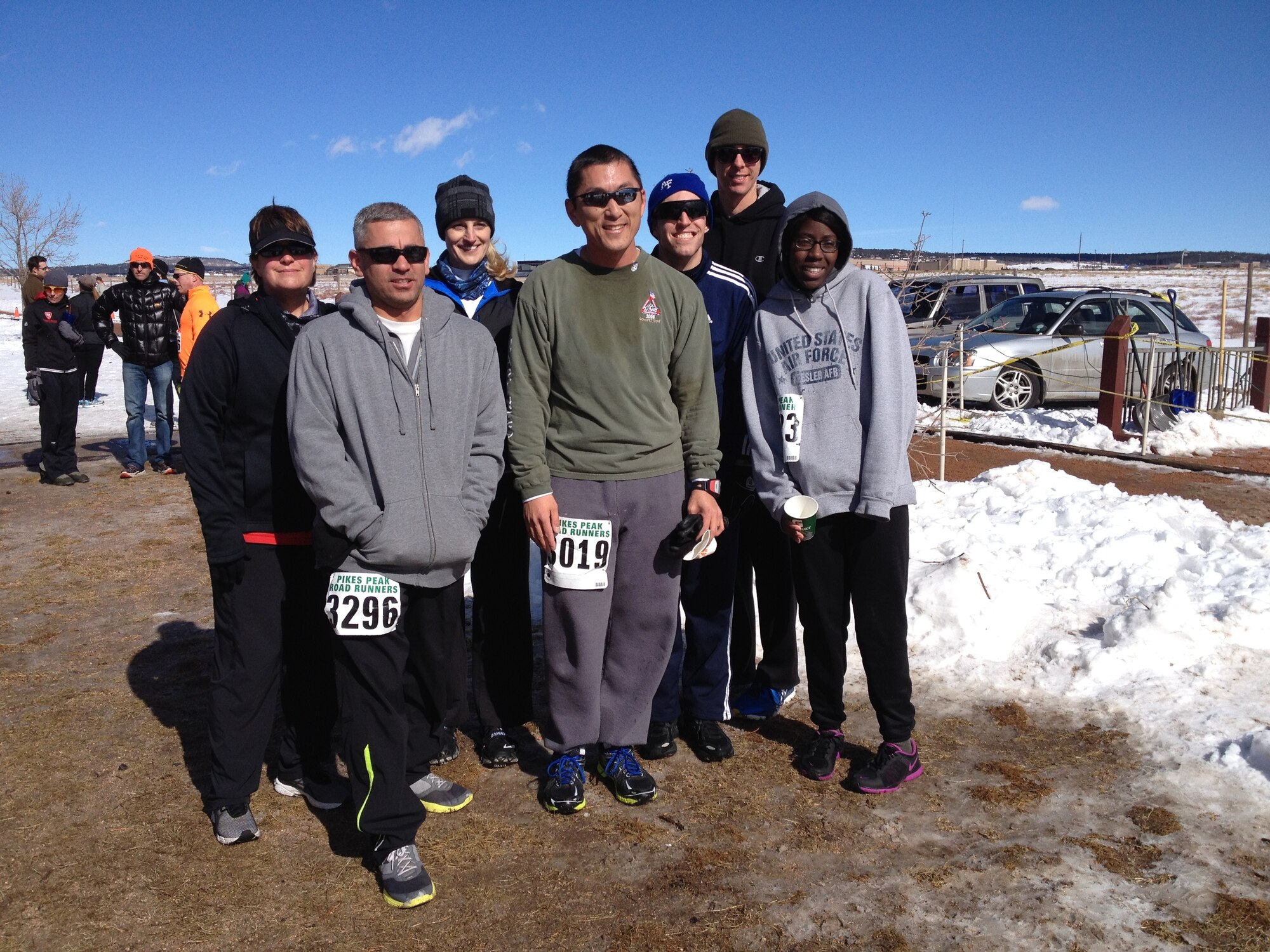 Senior Master Sgt. Tammy Gaudu, 460th Space Communication Squadron flight chief, (left) and Capt. Brian Thorn, 460th SCS flight commander, (right) pose with other Team Buckley members after completing the Pike’s Peak Road Runners race Jan. 25, 2014. Gaudu and Thorn are training to run in the Air Force Marathon as part of the Air Force Space Command team. (Courtesy photo)