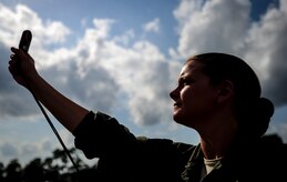 Maj. Jen Remmers, 910th Airlift Wing, Youngstown Air Reserve Station, Ohio, checks the wind speed June 25, 2014, at Joint Base Charleston, South Carolina. The C-130 Hercules and crew sprayed for mosquitos on JB Charleston and is the only unit of its kind in the Air Force. (U.S. Air Force photo/Senior Airman Dennis Sloan) 


