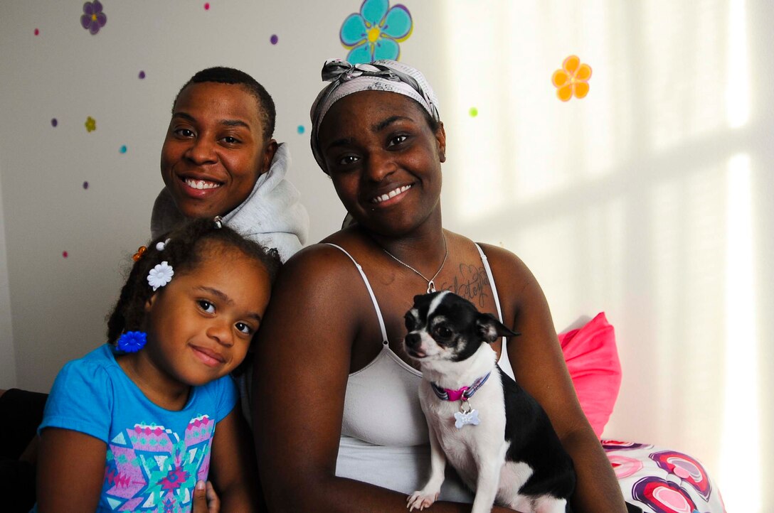 U.S. Air Force Staff Sgt.Sharnique Braxton, 440th Supply Chain Operations Squadron computer operations analyst, sits with her wife, U.S. Army Sgt. LaToya Morris, and daughter, Diamond, at their home near Langley Air Force Base, Va., June 25, 2014. Braxton entered the Air Force before the repeal of "Don't ask, Don't tell" in 2011, and endured hardships due to her sexual-preference before and after the repeal. (U.S. AIr Force photo by Senior Airman Austin Harvill/Released) (photo cropped and color corrected for affect)