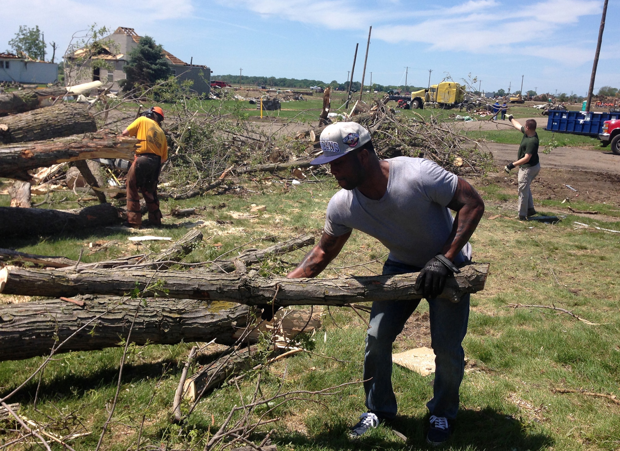 (Left to Right) U.S Air Force Staff Sgt. Justin Lewis, a contracting specialist from the 55th Contracting Squadron at Offutt Air Force Base, Nebraska, helps remove debris June 21 in Pilger, Nebraska. Lewis volunteered to help with the cleanup of Pilger following a tornado that struck the town June 16. Approximately 75 percent of the town was destroyed by the tornado. (Courtesy photo)
