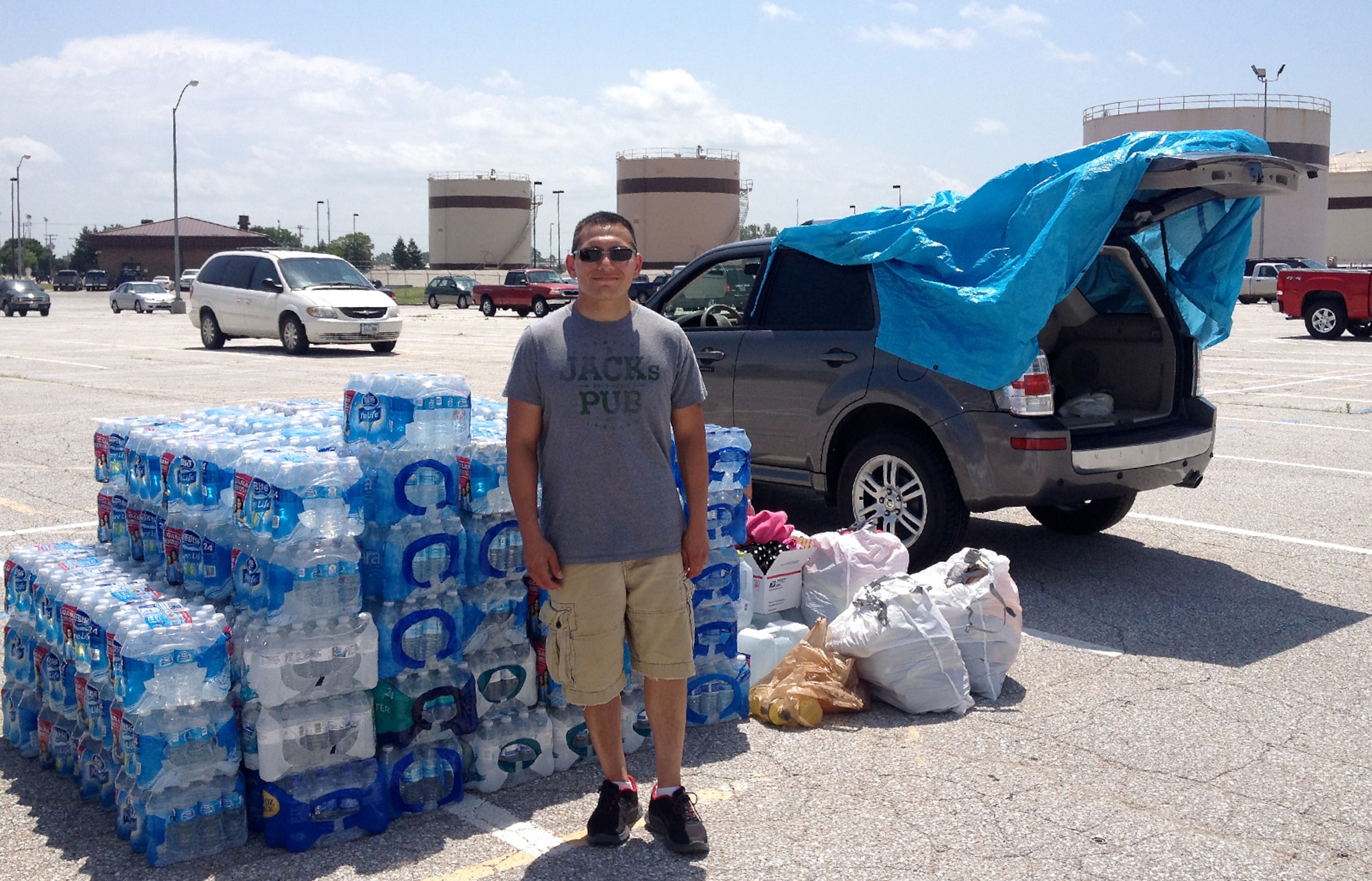 U.S. Air Force Staff Sgt. Tad Mendez, an instructor from the 338th Combat Training Squadron at Offutt Air Force Base, Nebraska, collects water at Offutt June 18 as part of relief efforts supporting the victims of a June 16 tornado that destroyed approximately 75 percent of Pilger, Nebraska. The 338th CTS collected 320 cases of water and Gatorade that was delivered to Pilger by the Salvation Army. (Courtesy photo)