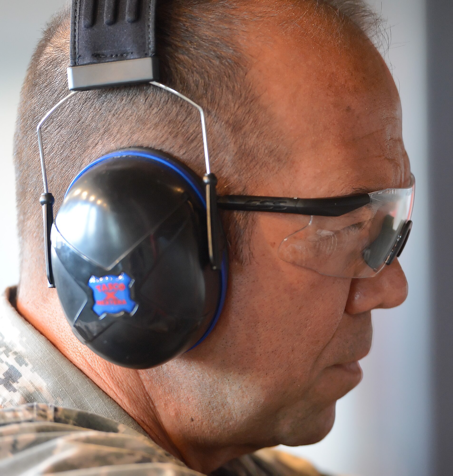 Col. Thomas Reppart, 436th Mission Support Group commander, wears eye and hearing protection while participating in a senior leaders??? shooting competition June 20, 2014, at Dover Air Force Base, Del. The training was held at the Combat Arms Training and Maintenance range operated by the 436th Security Forces Squadron. (U.S. Air Force photo/Greg L. Davis)