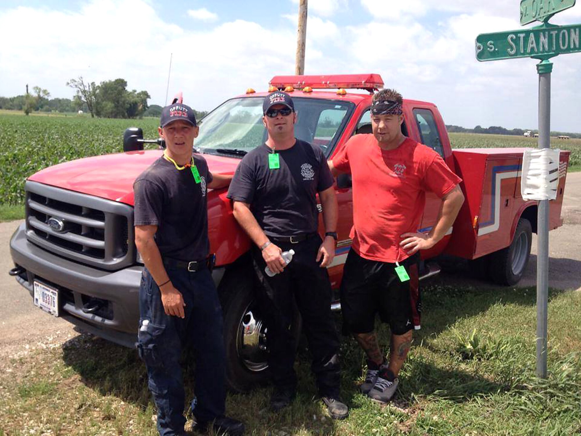 (Left to right) Jason Livermore, Ron Dawson and Nate Radenslaben, firefighters from the 55th Civil Engineering Squadron at Offutt Air Force Base, Nebraska, take a break from removing debris in Pilger, Nebraska, June 18. They volunteered to help with cleanup efforts following a June 16 tornado that destroyed approximately 75 percent of Pilger. (Courtesy photo)