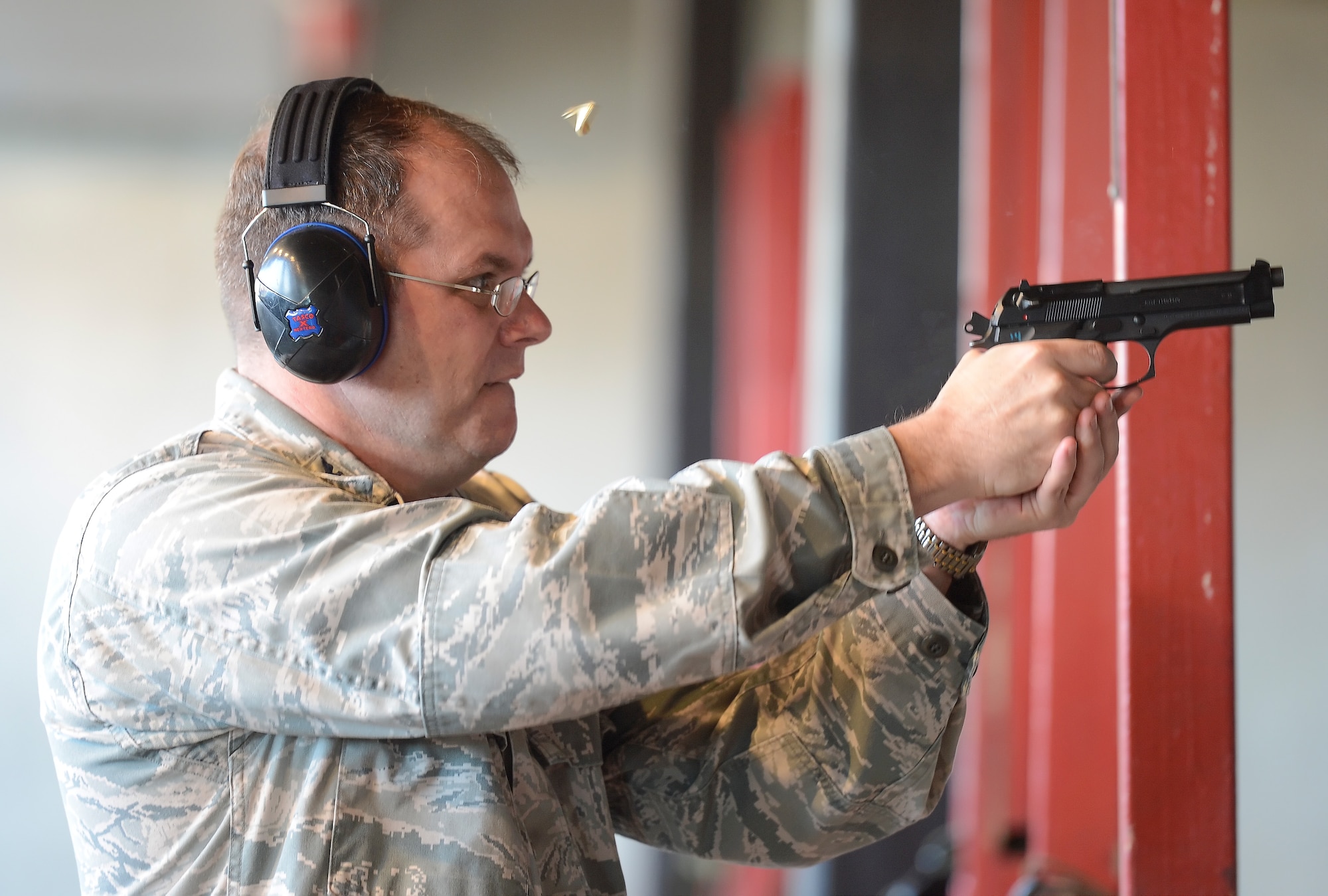 Col. Rick Moore, 436th Airlift Wing commander, concentrates while firing a 9 mm Beretta pistol during a marksmanship skills refresher June 20, 2014, at Dover Air Force Base, Del. The competition was held at the Dover AFB shooting range operated by the 436th Security Forces Squadron. (U.S. Air Force photo/Greg L. Davis)