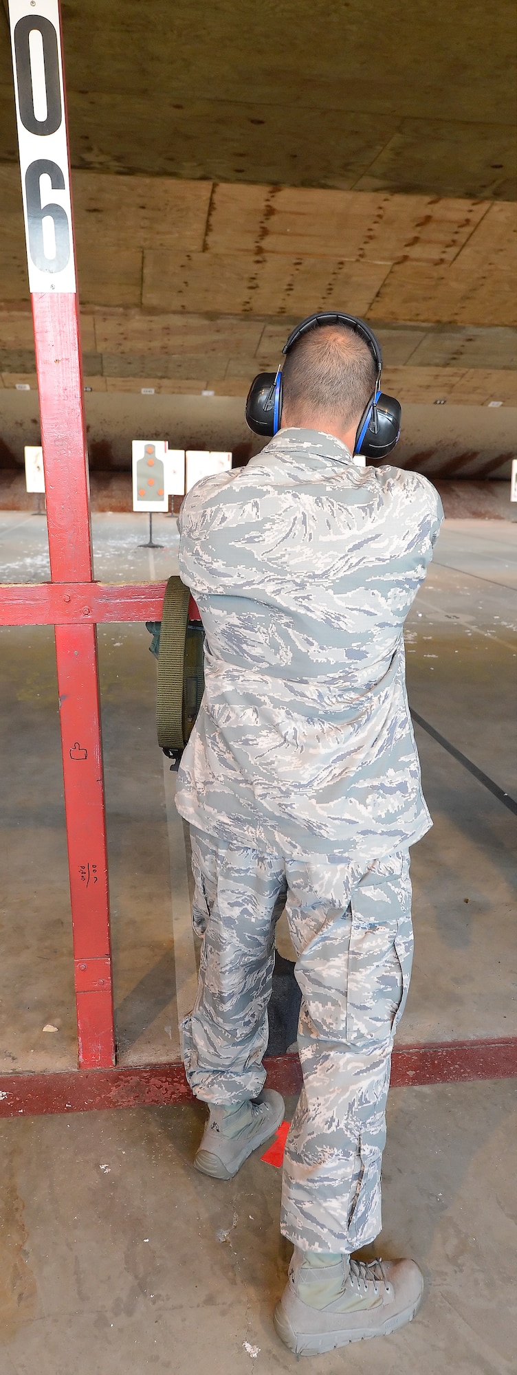 Col. Thomas Reppart, 436th Mission Support Group commander, shoots from a standing position on firing lane 06 while participating in a senior leaders??? shooting competition June 20, 2014, at Dover Air Force Base, Del. The competition was held at the Combat Arms Training and Maintenance range operated by the 436th Security Forces Squadron. (U.S. Air Force photo/Greg L. Davis)