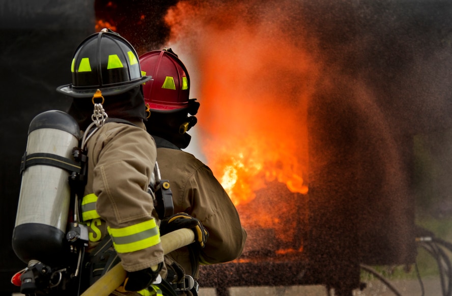 Members of the Burlington Fire Department put out a fire during training in Burlington, N.D., June 23, 2014. Burlington Fire Department is based solely on volunteerism, and they respond to 50-70 calls per year ranging, from wild land to structure fires.  (U.S. Air Force photo/Senior Airman Brittany Y. Bateman)