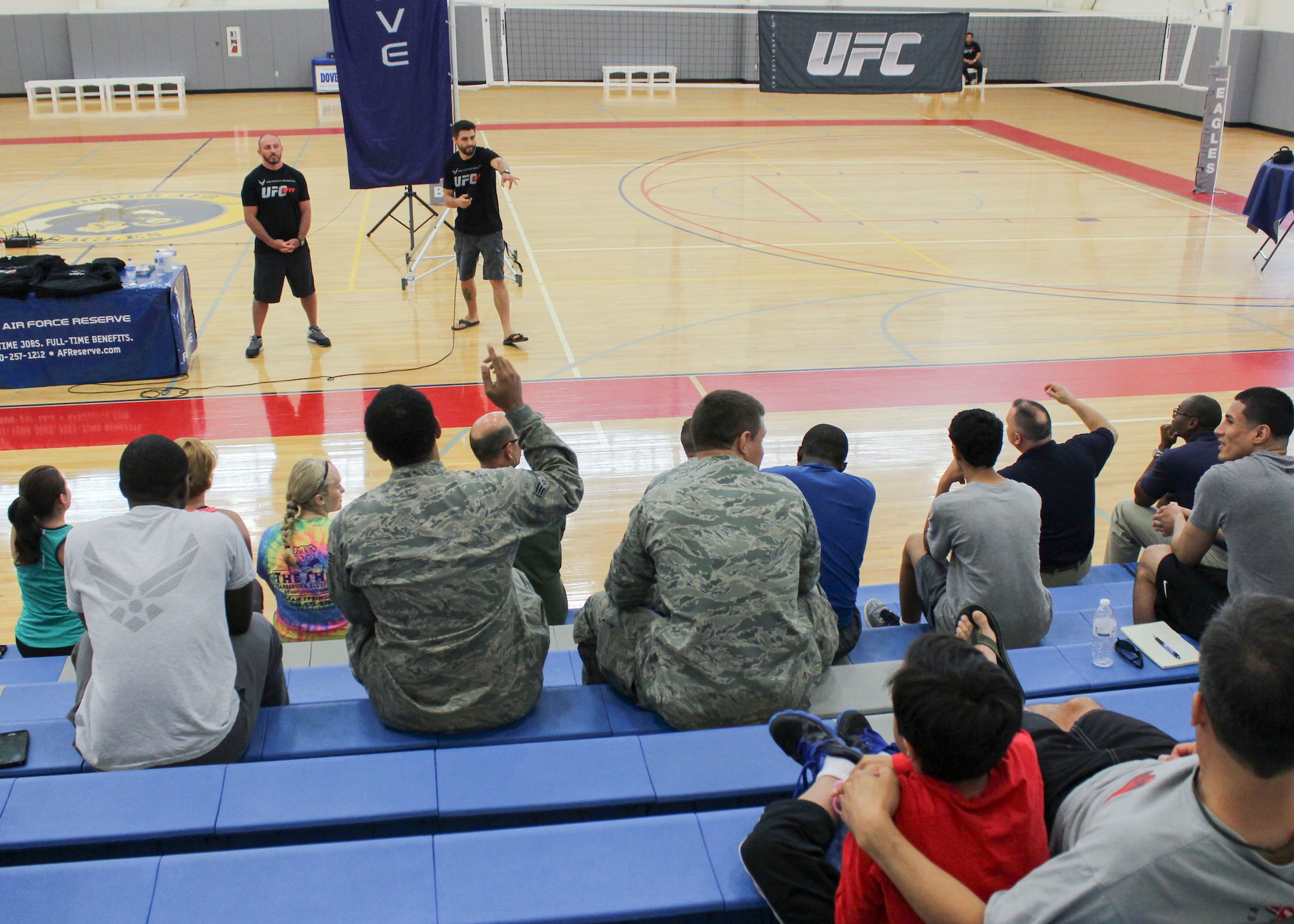 Mike Dolce, Ultimate Fighting Championship coach, and Carlos Condit, UFC fighter, talk to Team Dover Airmen and civilian personnel June 26, 2014, at the fitness center on Dover Air Force Base, Del. The event’s purpose was to educate Airmen on the benefits of living a healthy and active lifestyle. (U.S. Air Force photo/Herbert E. Welday III)