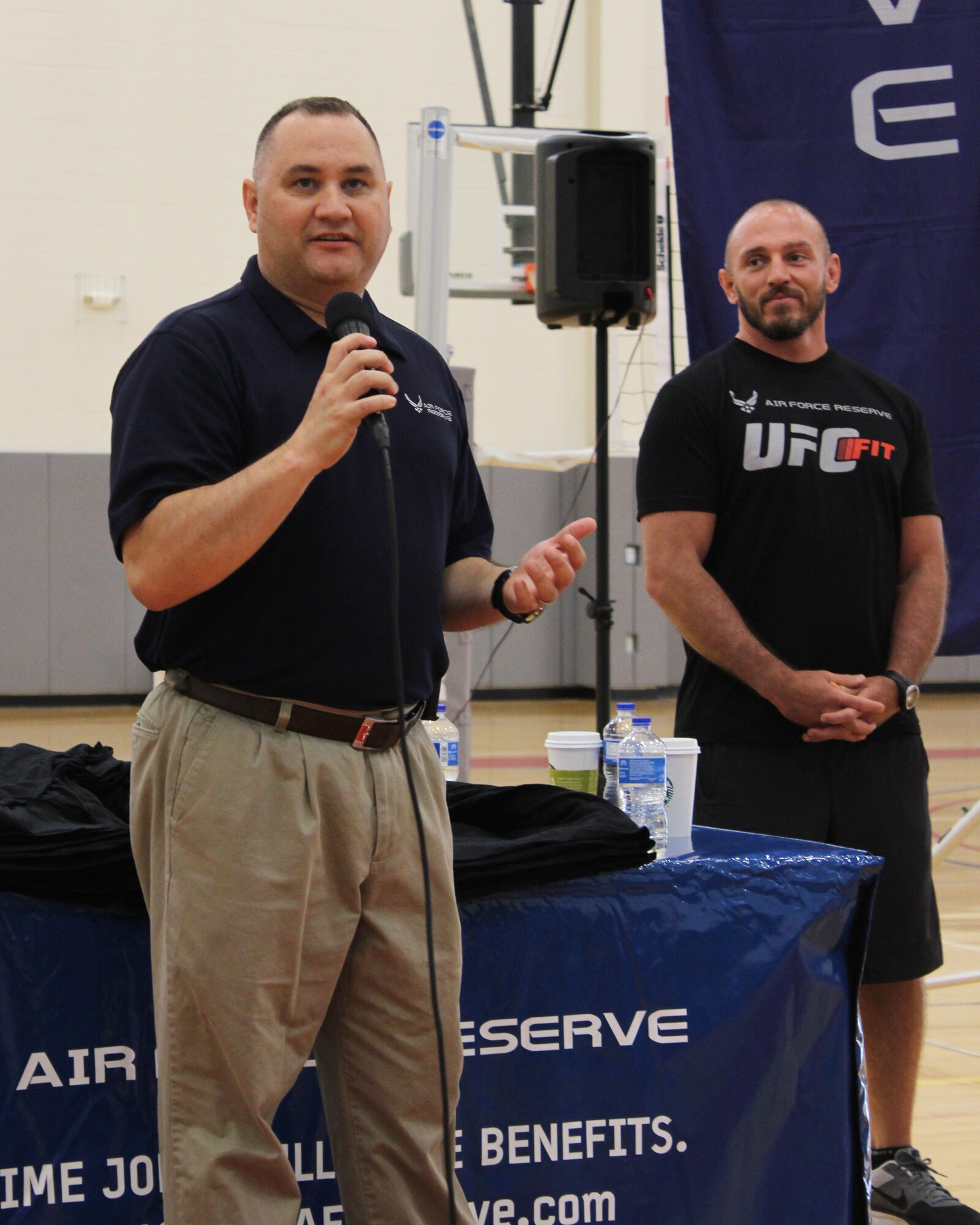 Senior Master Sgt. David Drake, 512th Airlift Wing reserve recruiting flight chief, speaks to a crowd attending the 2014 UFC Fit Tour June 26, 2014, at the fitness center on Dover Air Force Base, Del. The tour was collaborative effort between UFC and The U.S. Air Force Reserve. (U.S. Air Force photo/Herbert E. Welday III)