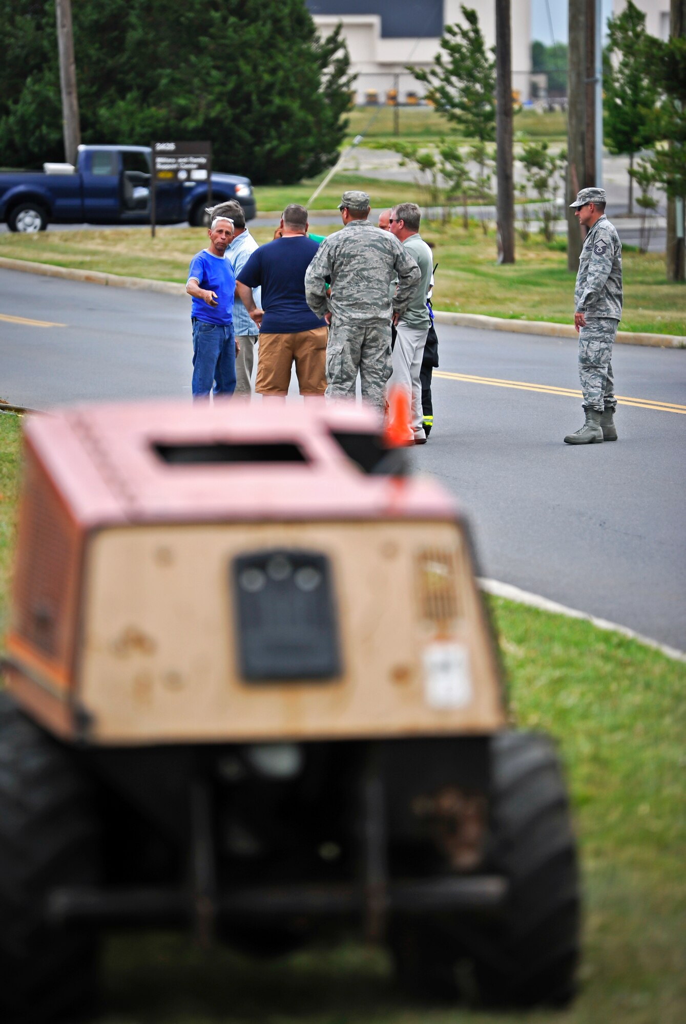 Members of the 87th Civil Engineer Squadron discuss a plan of action after arriving at a scene of a broken gas line June 25, 2014, at Joint Base McGuire-Dix-Lakehurst, N.J. Firefighters, emergency management personnel and security forces teamed up after arriving the call and defused the situation by shutting the gas off, evacuating the nearest building and setting up an alternate traffic route. (U.S. Air Force photo by Staff Sgt. Scott Saldukas/Released)