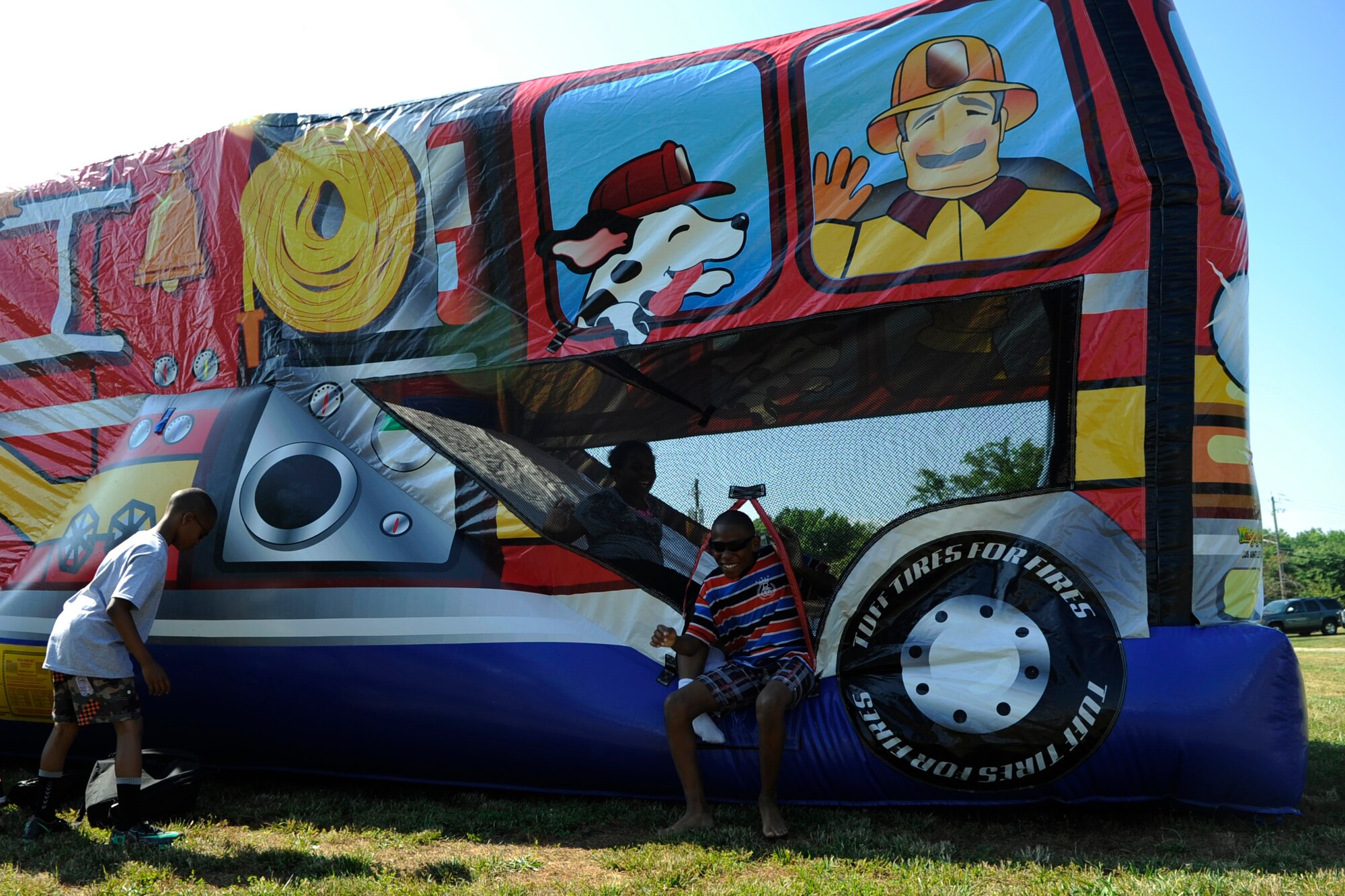 Emmanuel Barnes, 11, crawls out of a jump house during Operation KID Mode on Joint Base Andrews, Md., June 27, 2014. This kid-friendly, pretend deployment in-processing experience is designed to familiarize children with what their parents do before they travel overseas. (U.S Air Force photo/Senior Airman Nesha Humes)