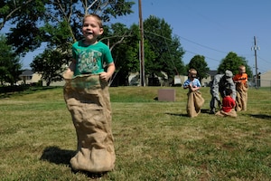 Justin Huddleston, 6, participates in a potato sack race during Operation KID Mode on Joint Base Andrews, Md., June 27, 2014. This is the third annual kid-friendly, pretend deployment in-processing event designed to familiarize children with their parents’ deployment experience. (U.S Air Force photo/Senior Airman Nesha Humes)