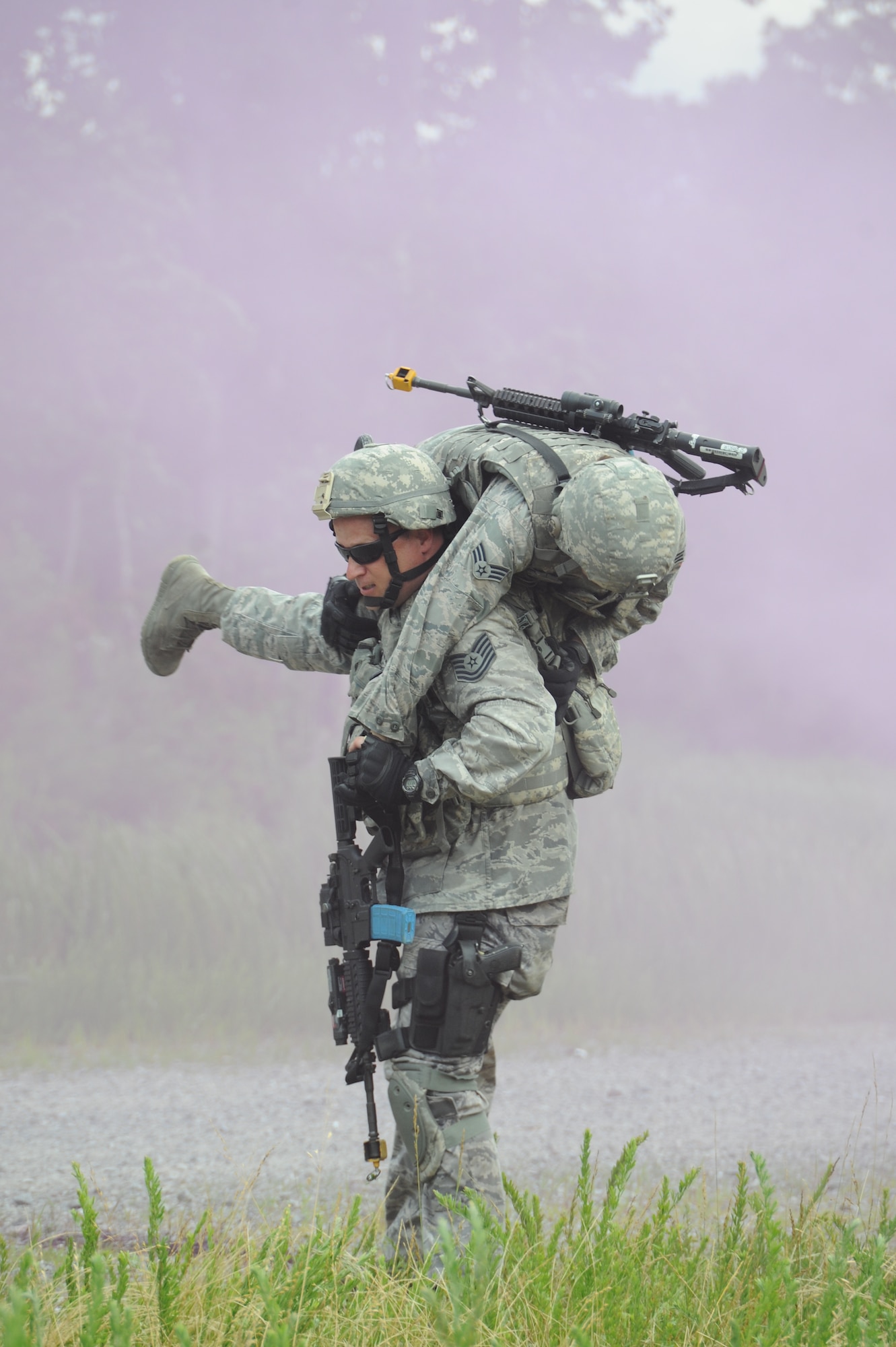 Tech. Sgt. Billy Burgan from the 87th Security Forces Squadron, Joint Base McGuire-Dix-Lakehurst, N.J., carries Senior Airmen Manitza Heras 162nd Security Forces Squadron, Tucson Air National Guard Base during Phoenix Warrior training June 25.  This is the final Phoenix Warrior class at the U.S. Air Force Expeditionary Center, Joint Base McGuire-Dix-Lakehurst, N.J., before all security forces deployment training is consolidated to Fort Bliss, Texas. (U.S. Air Photo/Brad Camara)