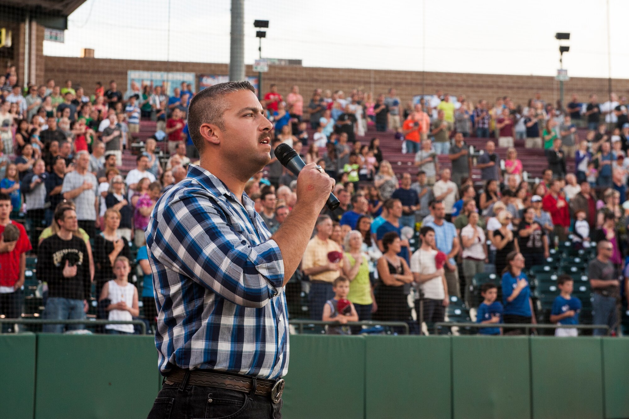 COLORADO SPRINGS, Colo. – Tech. Sgt. Andrew Decker, 21st Aerospace Medicine Squadron, sings the national anthem prior to the start of the second game of a double header at the Colorado Springs Sky Sox Military Appreciation event June 26. The Sky Sox lost the first game to the Iowa Cubs, but won the second game 7-6. (U.S. Air Force photo/Philip Carter)