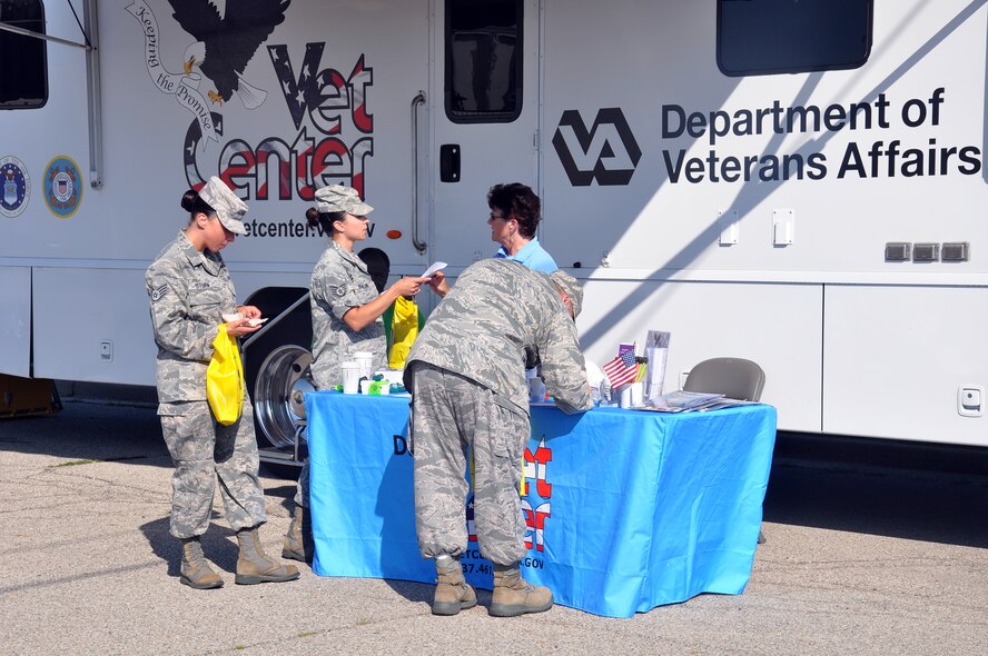 WRIGHT-PATTERSON AIR FORCE BASE, Ohio – Beth Stearns, social worker with the Department of Veterans Affairs Mobile Vet Center, meets with Airmen from the 445th Airlift Wing and shares information about the MVC during the Psychological Health Advocacy Program Post Traumatic Stress Disorder (PTSD) Awareness Day event held here June 27, 2014. Approximately 85 people visited the PHAP information booth and received information about the disorder and the help that is available. Vet Centers guide veterans and their families through many of the major adjustments in lifestyle that often occur after a veteran returns from combat. Services may include individual and group counseling in areas such as PTSD, alcohol and drug assessment, and suicide prevention referrals. (U.S. Air Force photo/Stacy Vaughn)