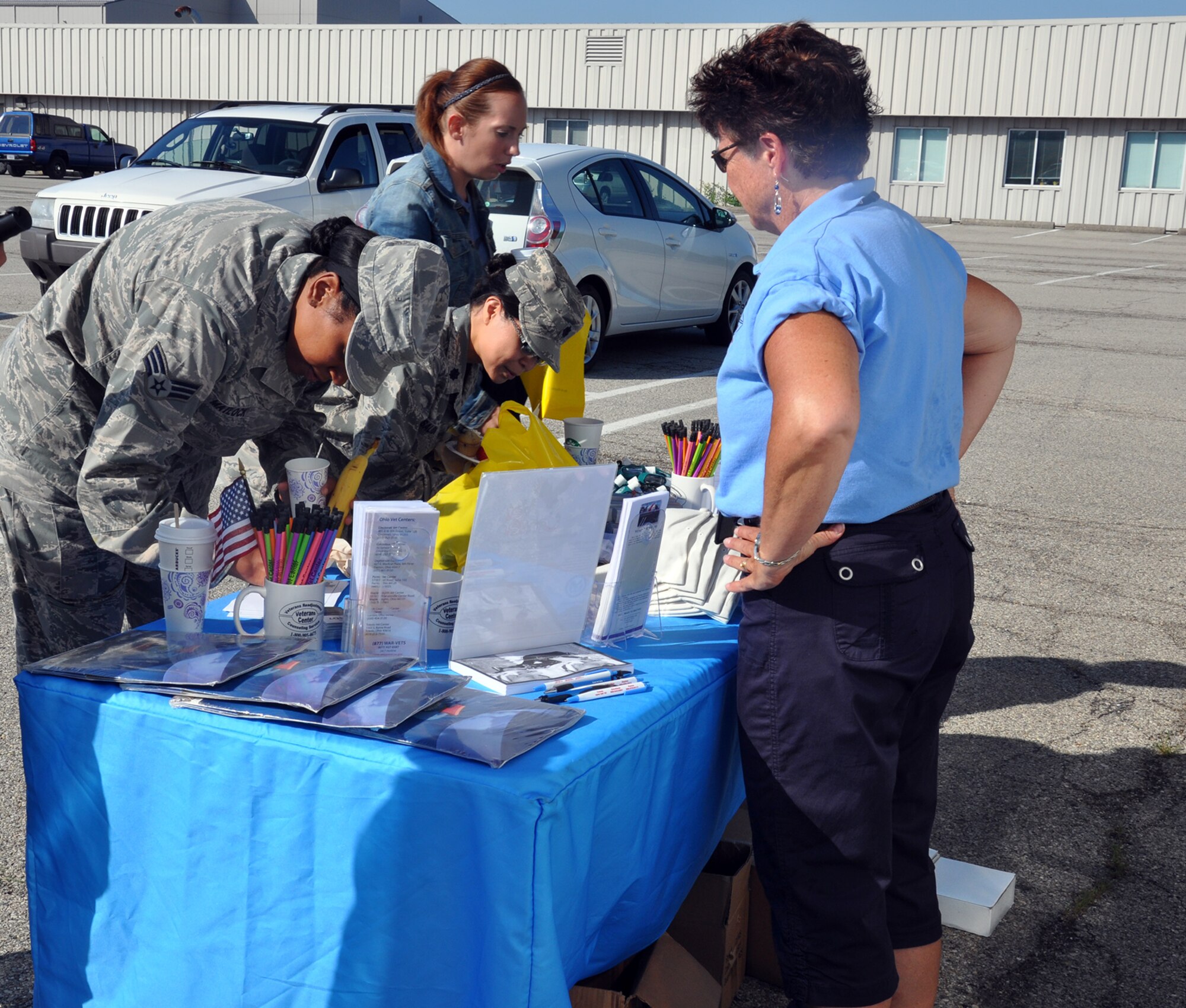WRIGHT-PATTERSON AIR FORCE BASE, Ohio – Beth Stearns, social worker with the Department of Veterans Affairs Mobile Vet Center, meets with Airmen from the 445th Airlift Wing and shares information about the MVC during the Psychological Health Advocacy Program Post Traumatic Stress Disorder (PTSD) Awareness Day event held here June 27, 2014. Approximately 85 people visited the PHAP information booth and received information about the disorder and the help that is available. Vet Centers guide veterans and their families through many of the major adjustments in lifestyle that often occur after a veteran returns from combat. Services may include individual and group counseling in areas such as PTSD, alcohol and drug assessment, and suicide prevention referrals. (U.S. Air Force photo/Stacy Vaughn)
