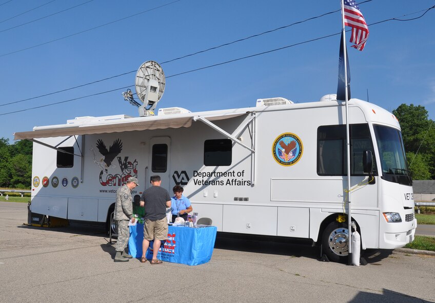 WRIGHT-PATTERSON AIR FORCE BASE, Ohio – Beth Stearns, social worker with the Department of Veterans Affairs Mobile Vet Center, meets with Airmen from the 445th Airlift Wing and shares information about the MVC during the Psychological Health Advocacy Program Post Traumatic Stress Disorder (PTSD) Awareness Day event held here June 27, 2014. Approximately 85 people visited the PHAP information booth and received information about the disorder and the help that is available. Vet Centers guide veterans and their families through many of the major adjustments in lifestyle that often occur after a veteran returns from combat. Services may include individual and group counseling in areas such as PTSD, alcohol and drug assessment, and suicide prevention referrals. (U.S. Air Force photo/Stacy Vaughn)