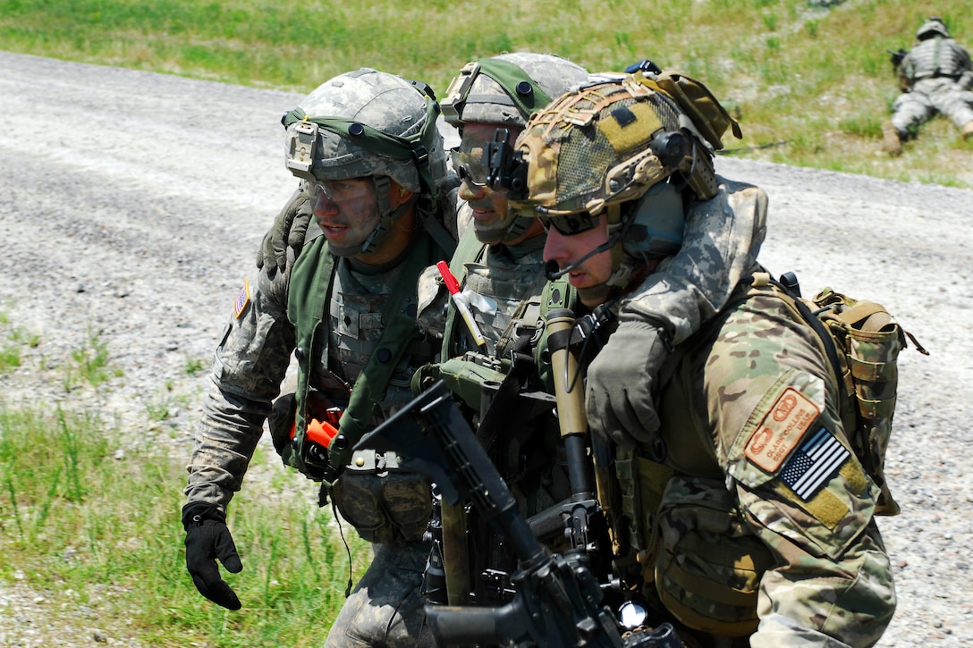 Air Force Tech. Sgt. Clark Collins helps infantrymen carry a wounded ...