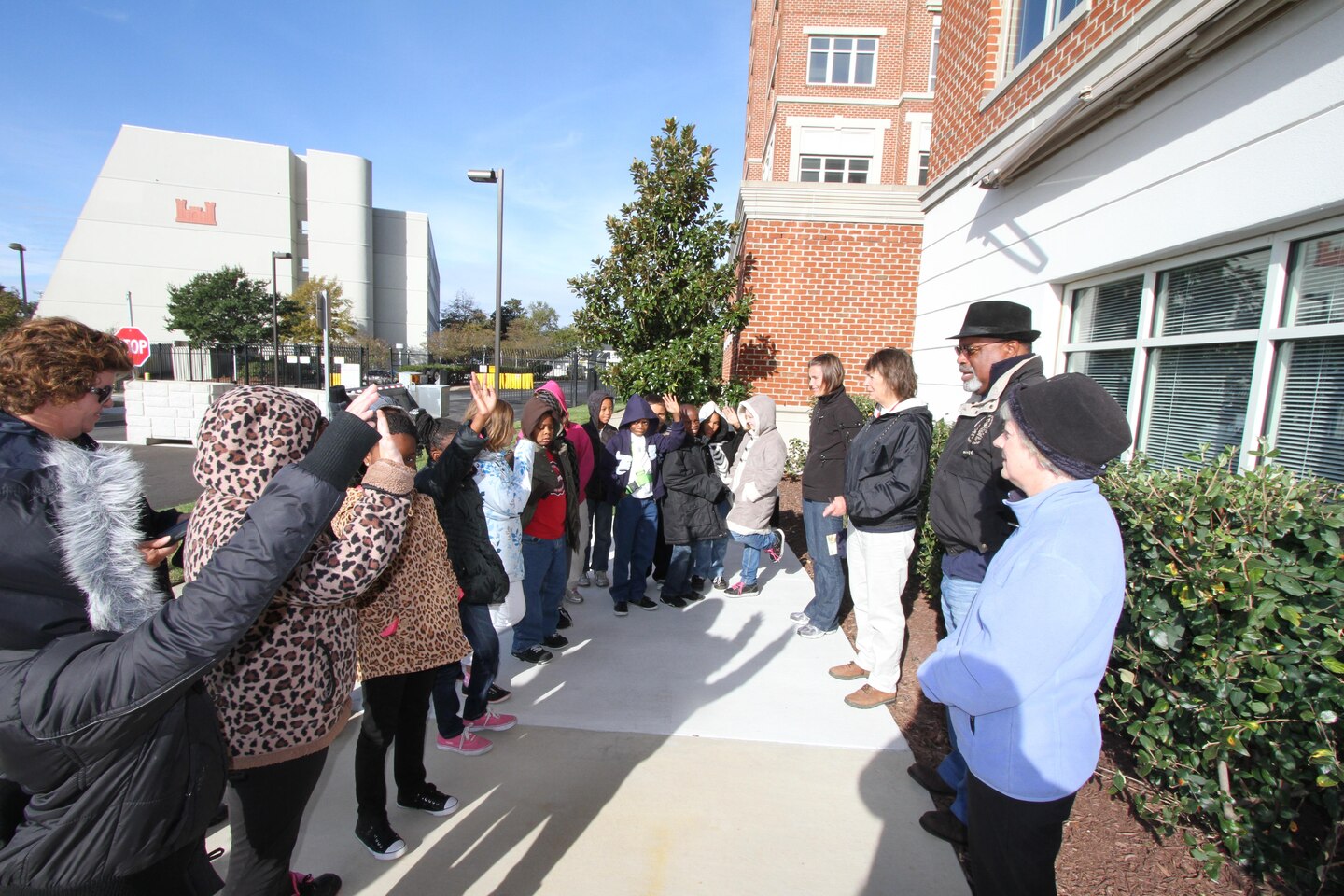 (Center) Rickey Brown of the Norfolk District Safety office administers a safety briefing Nov. 1, 2012, to 17 Seatack Elementary School 4th graders, upon arrival at the district. Far right: Jessica Grell, Seatack Elementary partner-teacher, Karin Dridge, Norfolk District Oyster Reef project manager, Betty Grey Waring, chief of Norfolk District’s Operations Branch, and (top left) Marie Culver, Seatack resource teacher. The students were on a field trip to learn about their environment and participate in oyster spat data collection.