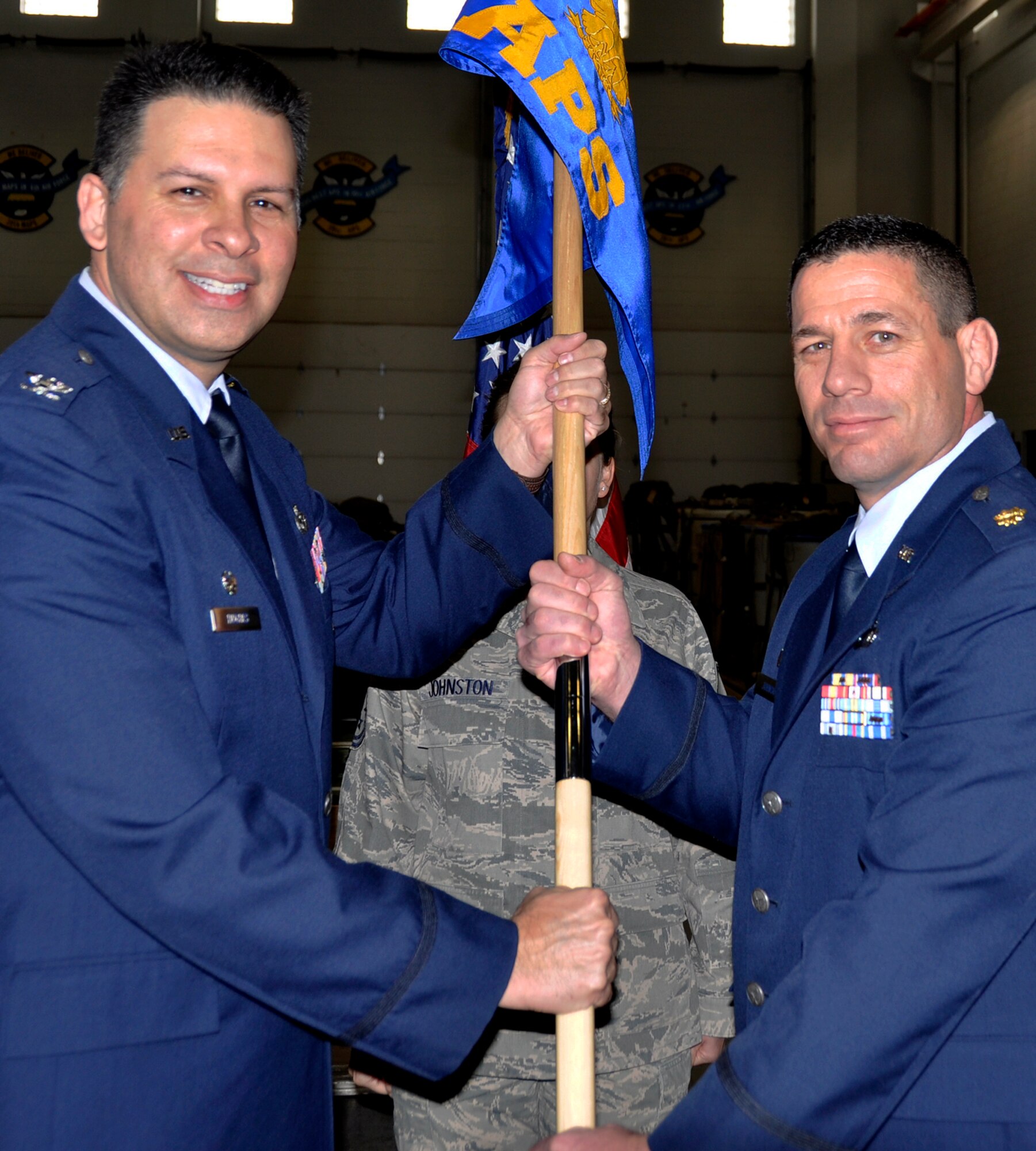 PETERSON AIR FORCE BASE, Colo. Maj. Royce Johnson, right, accepts the 39th Aerial Port Squadron guideon Col. Marty Hughes, Mission Support Group commander during the 39th APS change of command ceremony March 1, 2014 here. Before taking command, Johnson was the 39th APS operations officer.
“First off, nobody gets here on their own, there’s a lot of people to thank,” said Johnson. “All of you back there, you guys make me look good every single day I am here. You guys are the ones putting countless hours out here, doing the work, taking care of the mission, making all of us up here look really, really good.”
Johnson assumed command from Maj. Deborah Ings. 
As commander of the 39th APS, Johnson is now responsible for overseeing all aerial port taskings in support of the 302nd Airlift Wing, including cargo, ramp and passenger services, and airdrop cargo systems. (Photo by Master Sgt. Daniel Butterfield)