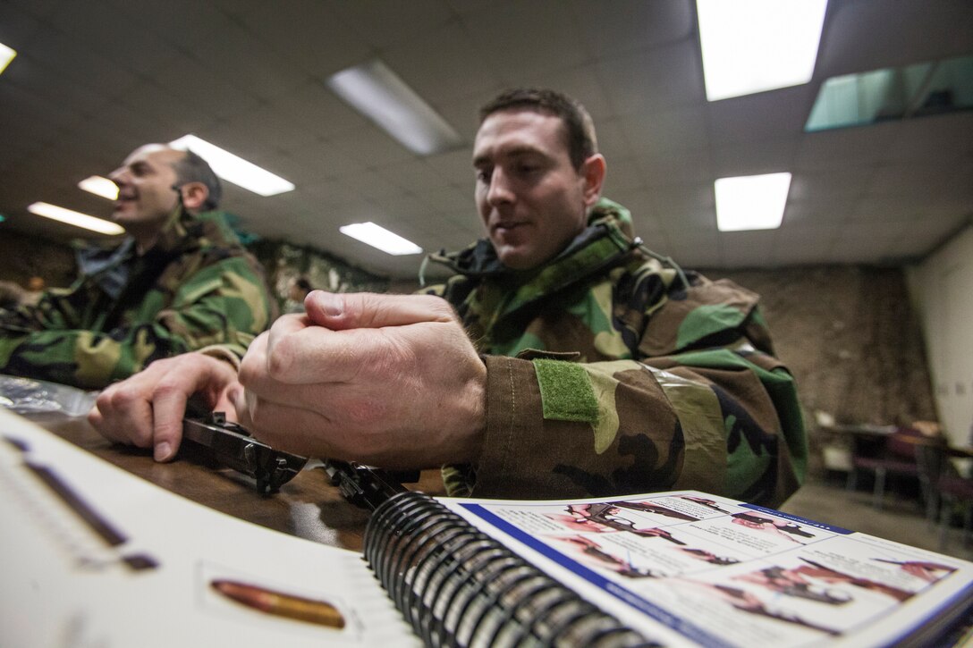 Tech. Sgt. Brandon Kehr, reassembles his Beretta M9 pistol as airmen from the 108th Wing, New Jersey Air National Guard, brush up on their chemical, biological, radiological and nuclear; self-aid buddy care; post attack reconnaissance and disassembling and reassembling Beretta M9 pistol and M16 rifle skills during the Wing's Ability to Survive and Operate Rodeo at Joint Base McGuire-Dix-Lakehurst, N.J. Feb. 9, 2014. The Wing-level evaluation shows what training areas need more focus. ATSO is used by airmen who are deploying or preparing for exercises or inspections. These skills make up the foundation necessary for all airmen to function effectively in hostile environments. (U.S. Air National Guard photo by Master Sgt. Mark C. Olsen/Released)