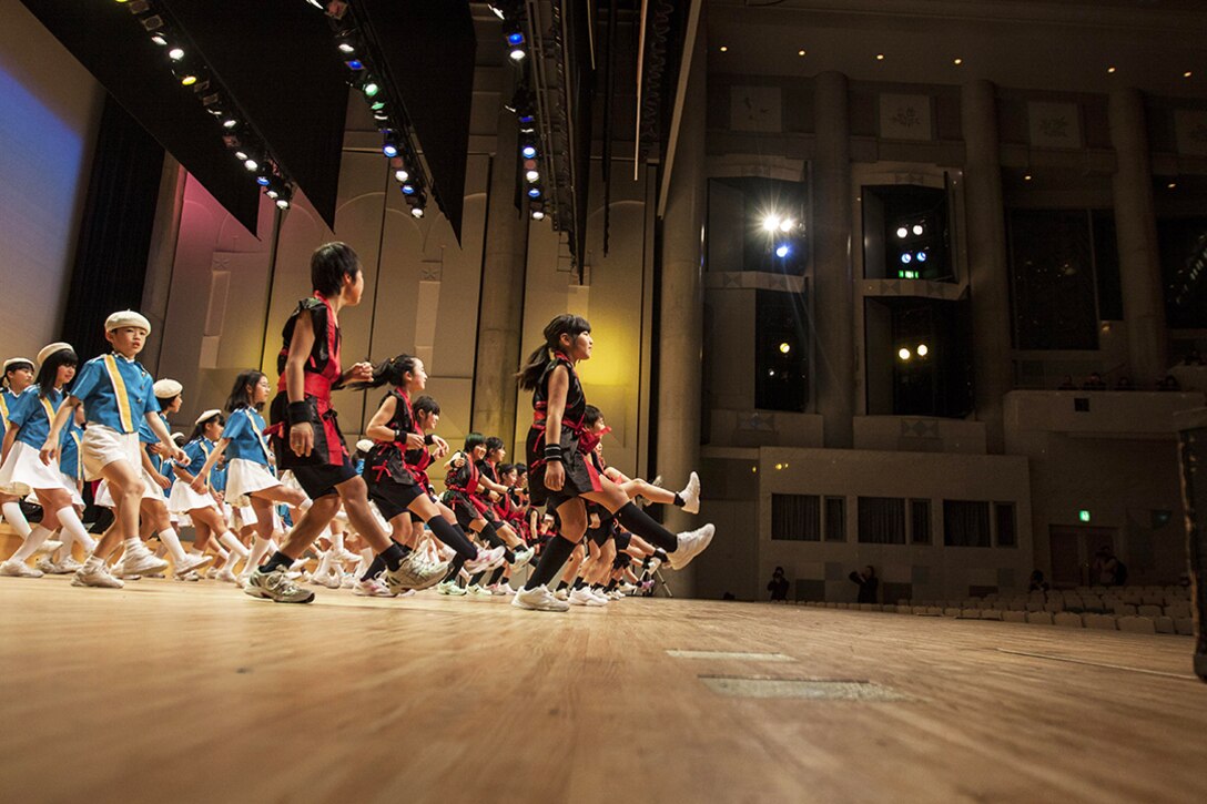 Participants of the 2014 U.S.-Japan Friendship Concert dance to the song "Cupid Shuffle" during the concert that took place inside the Iwakuni Sinfonia Feb. 15. Several schools from out in Iwakuni and Matthew C. Perry Schools attended the event.